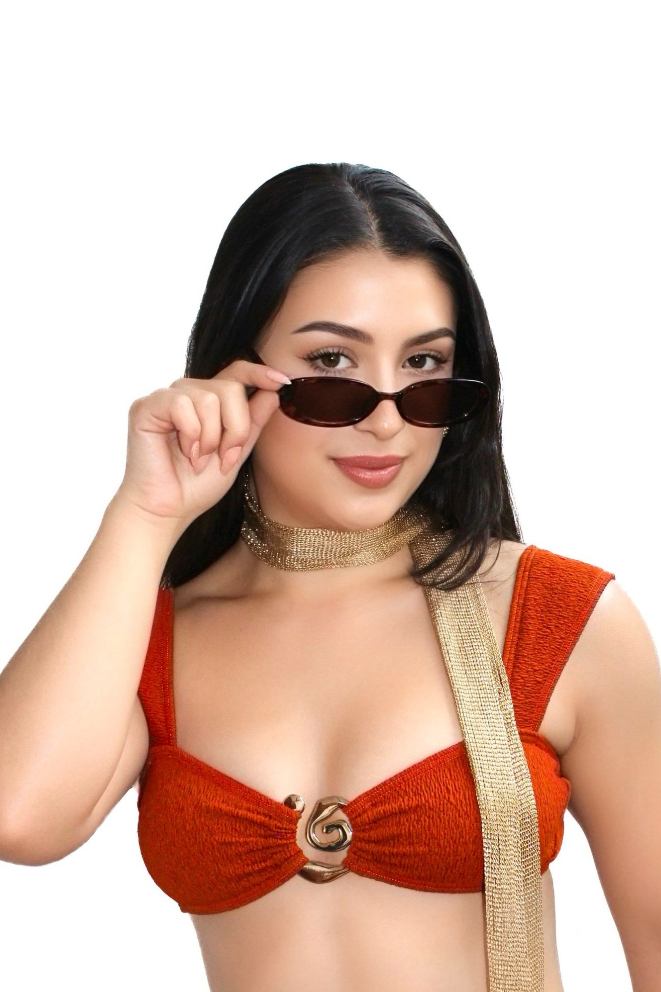 Close-up of gold swirl centerpiece on textured burnt orange bikini top from Meena Swim