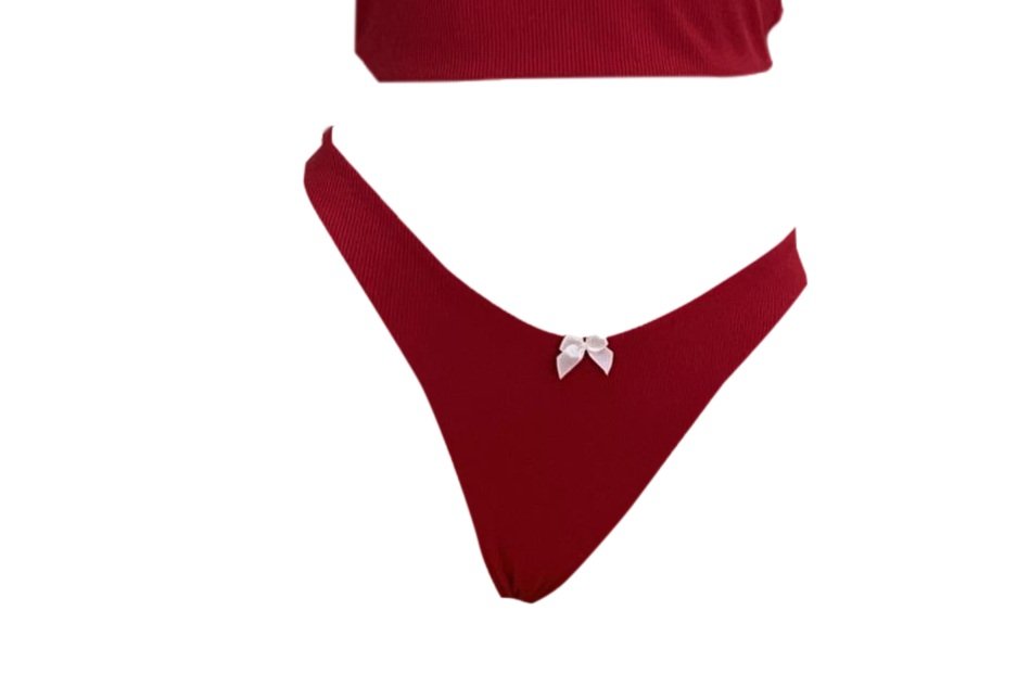 Red ribbed cheeky bikini bottoms with bow accent, perfect for a retro beach look from Meena Swims"