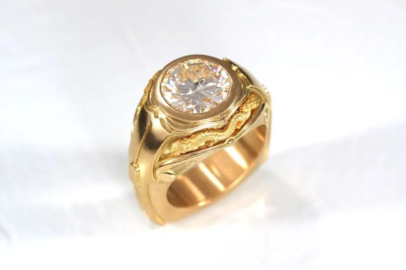 Custom 18K Gold Dragon & Diamond Ring
Commissioned as a unique statement piece, this 18K gold ring features a commanding 4.5-carat round diamond at its center. Two 22K gold dragons flank the stone, representing strength and protection. Designed speci