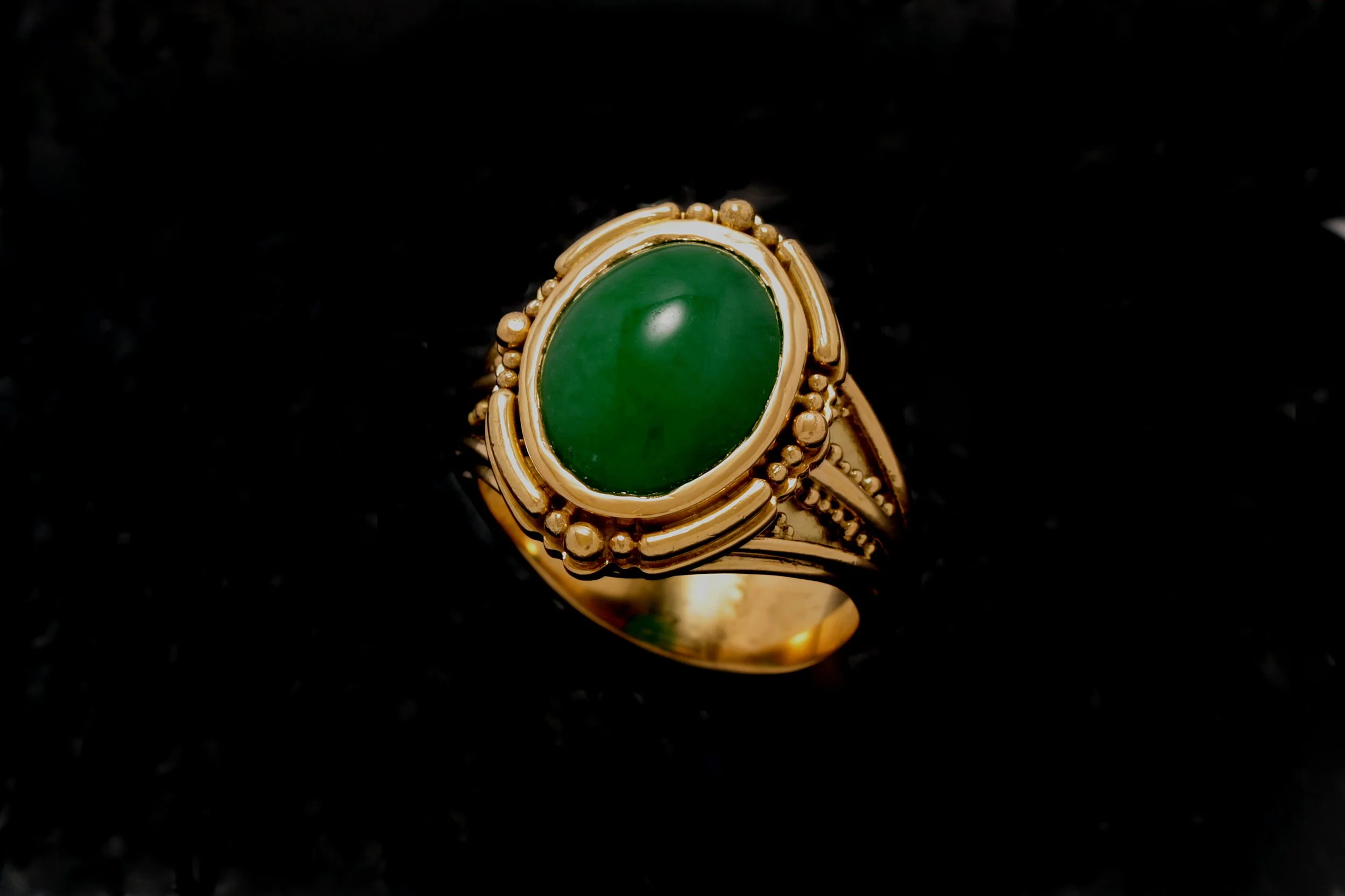 
Here are the descriptions for the bottom row of jewelry pieces:

Apple Green Jadeite Platform Ring
This commissioned piece showcases a vibrant apple-green jadeite, an untreated and highly sought-after variety of jade. The stone is set in a meticulou