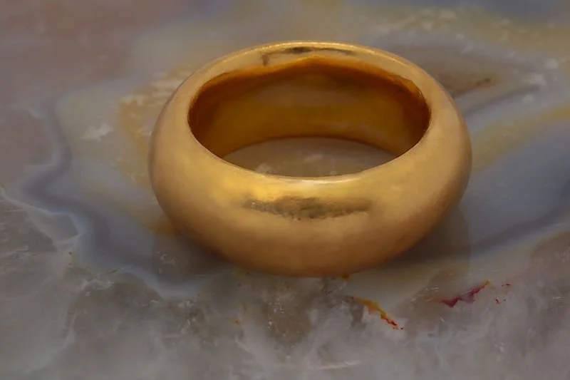 22K Heavyweight Gold Band
A minimalist yet bold statement, this plain band is anything but ordinary. Crafted in 22K gold, it weighs nearly an ounce, making it a substantial and luxurious piece. Designed for a client who appreciates the feel of heavy 