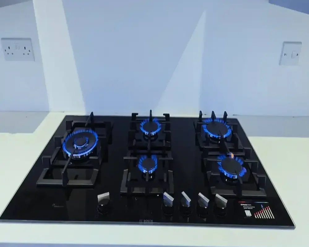 A flawlessly installed, premium Bosch FlameSelect gas hob by Eastside Gas LTD. All five burners demonstrating safe, clean blue flames, verifying professional, compliant engineering.