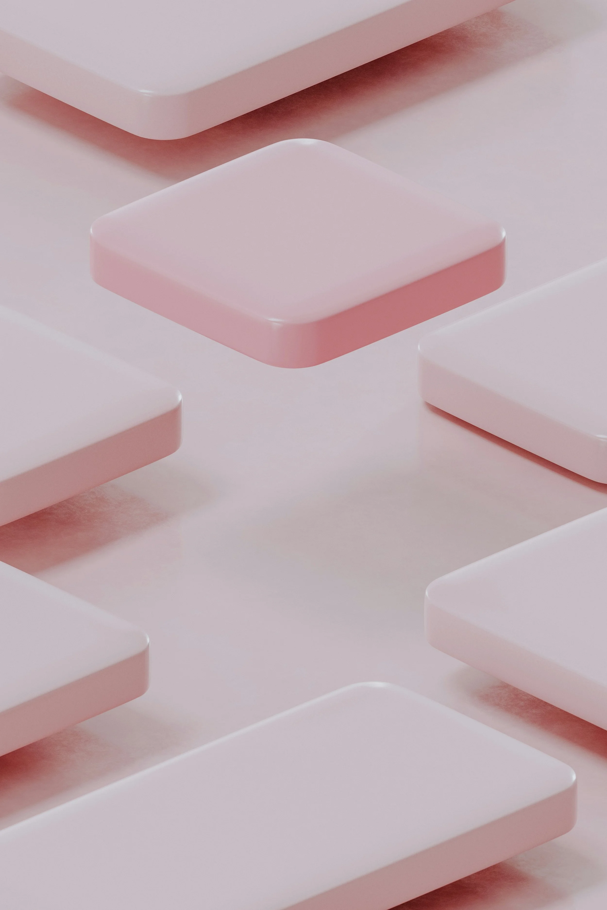 Abstract composition of pink and white rectangular blocks with rounded edges, arranged in a staggered pattern on a smooth surface.