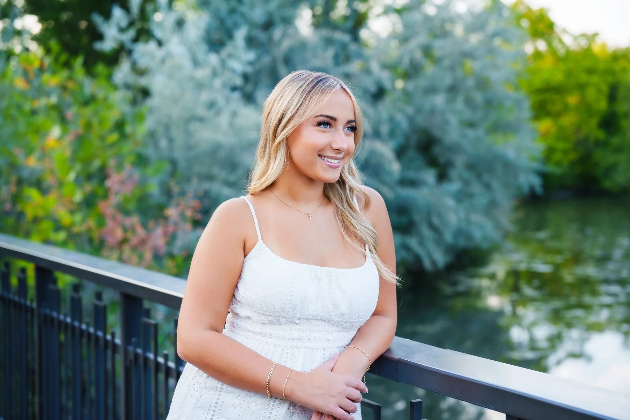 Senior Session near me at Kathryn Alberton park. Eagle high school senior all in white with a beautiful backdrop behind her. Boise/Eagle/Meridian/Star photographer in the treasure Valley.