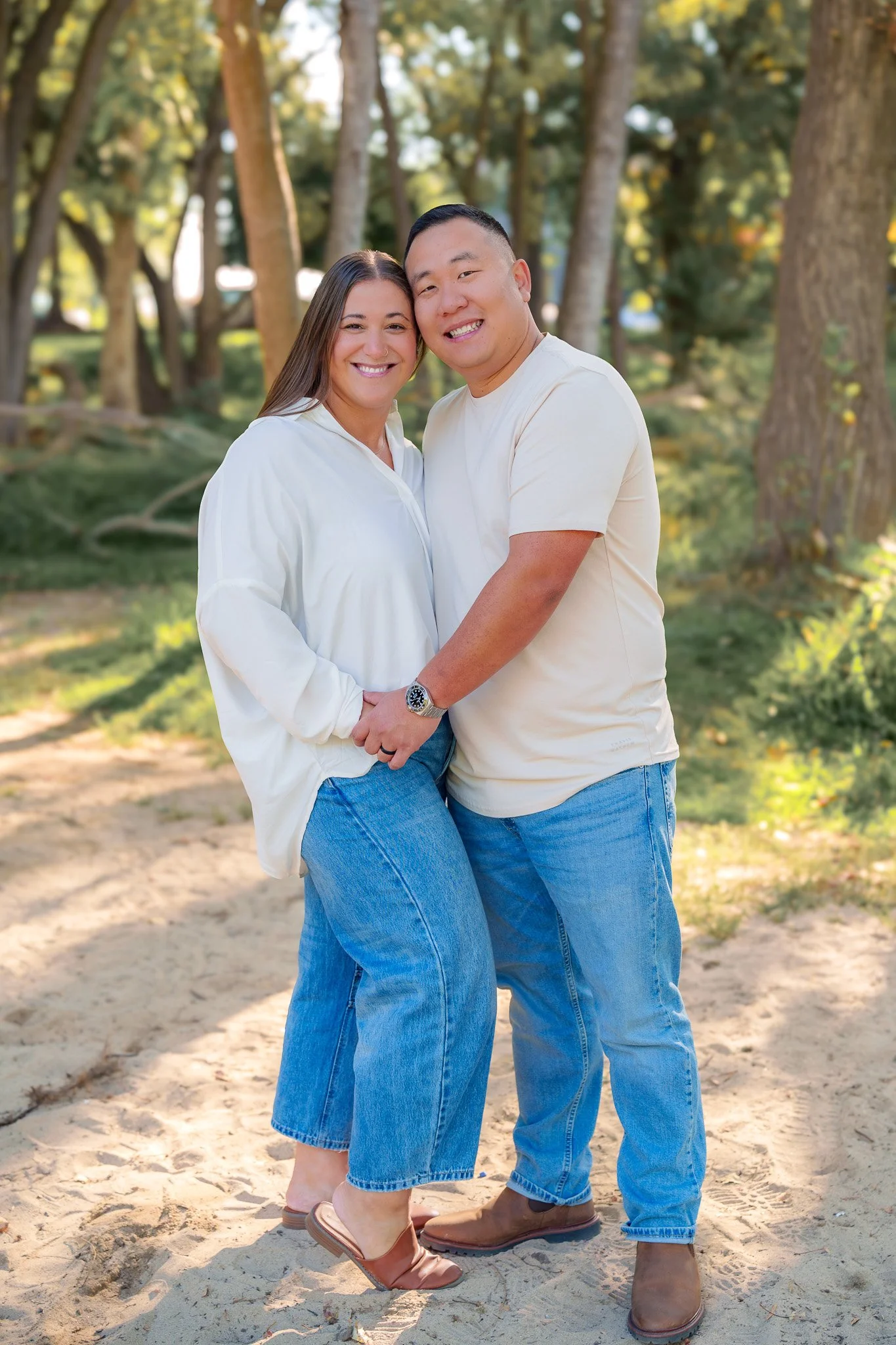  Family photo session with forever my media. Down by the Boise river in Eagle Idaho a couple smiles as their kids watch on.