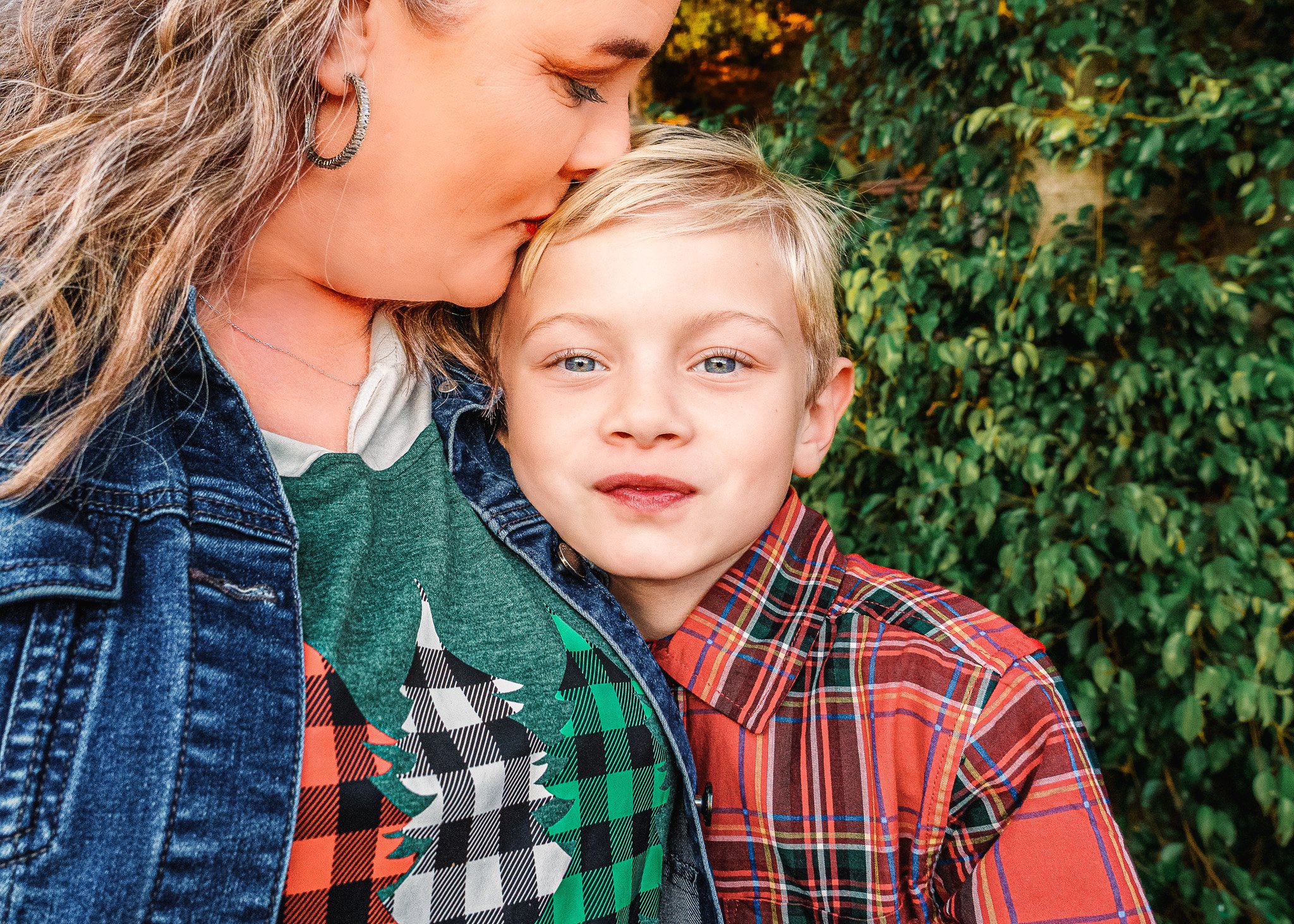 Candid family photo session in Star, Idaho featuring a sweet moment between mother and son in vibrant flannel shirts. Lifestyle photography that celebrates love and warmth for families in Star, Eagle, Meridian, Boise, and the Treasure Valley.