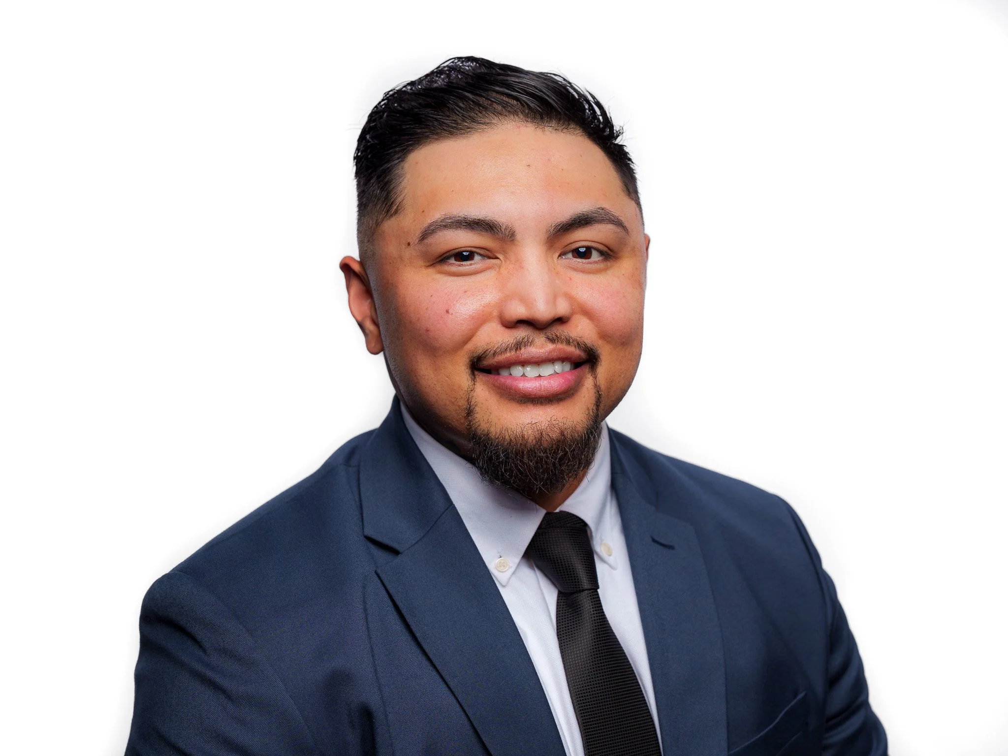 Professional corporate headshot of a male client in a navy suit and black tie, photographed on a clean white background in Boise, Idaho. Clean, modern branding photography for business professionals and entrepreneurs in Boise, Eagle, Meridian, Star, 