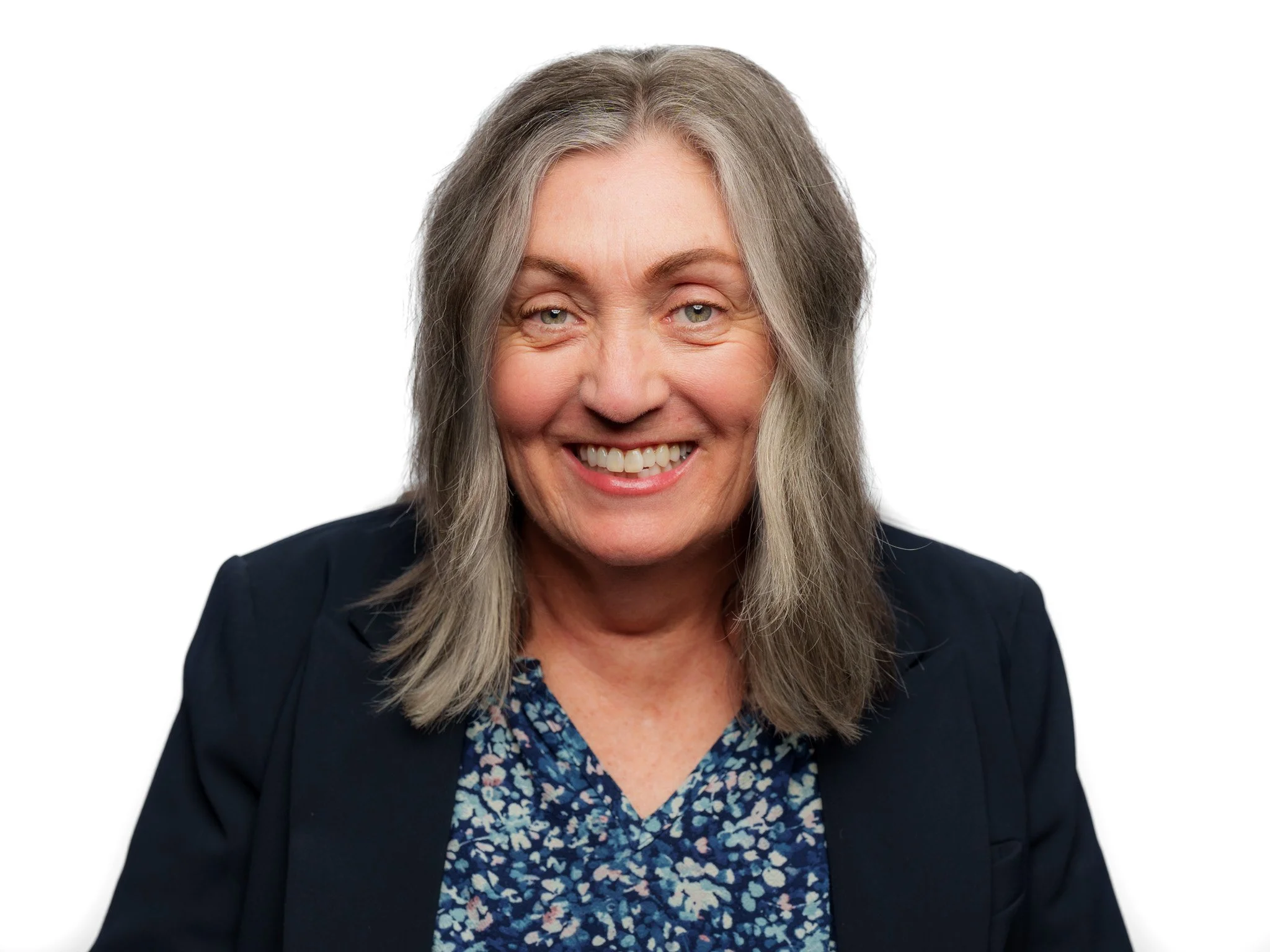 Professional headshot with a clean white background, showcasing a warm and approachable female client in a navy blazer. Branding portraits for business professionals and entrepreneurs in Boise, Meridian, Eagle, Star, and the Treasure Valley. Forever 