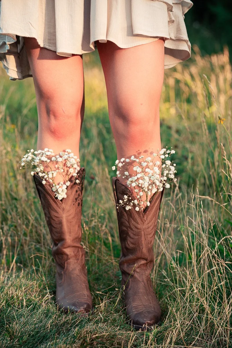 Cowboy boots with flowers inside of them during this cute senior/grad session in Boise/Eagle