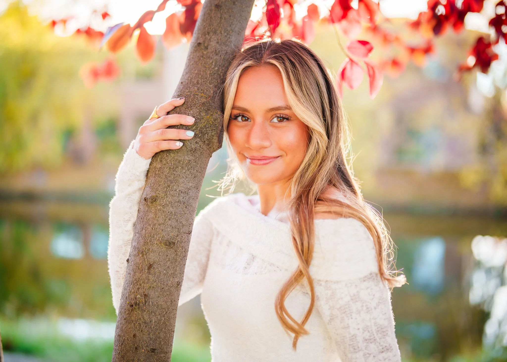 Soft golden light and fall colors made this senior photo session at Merrill Park in Eagle feel magical. Her natural smile and warm tones are what I love most about photographing seniors across the Treasure Valley.