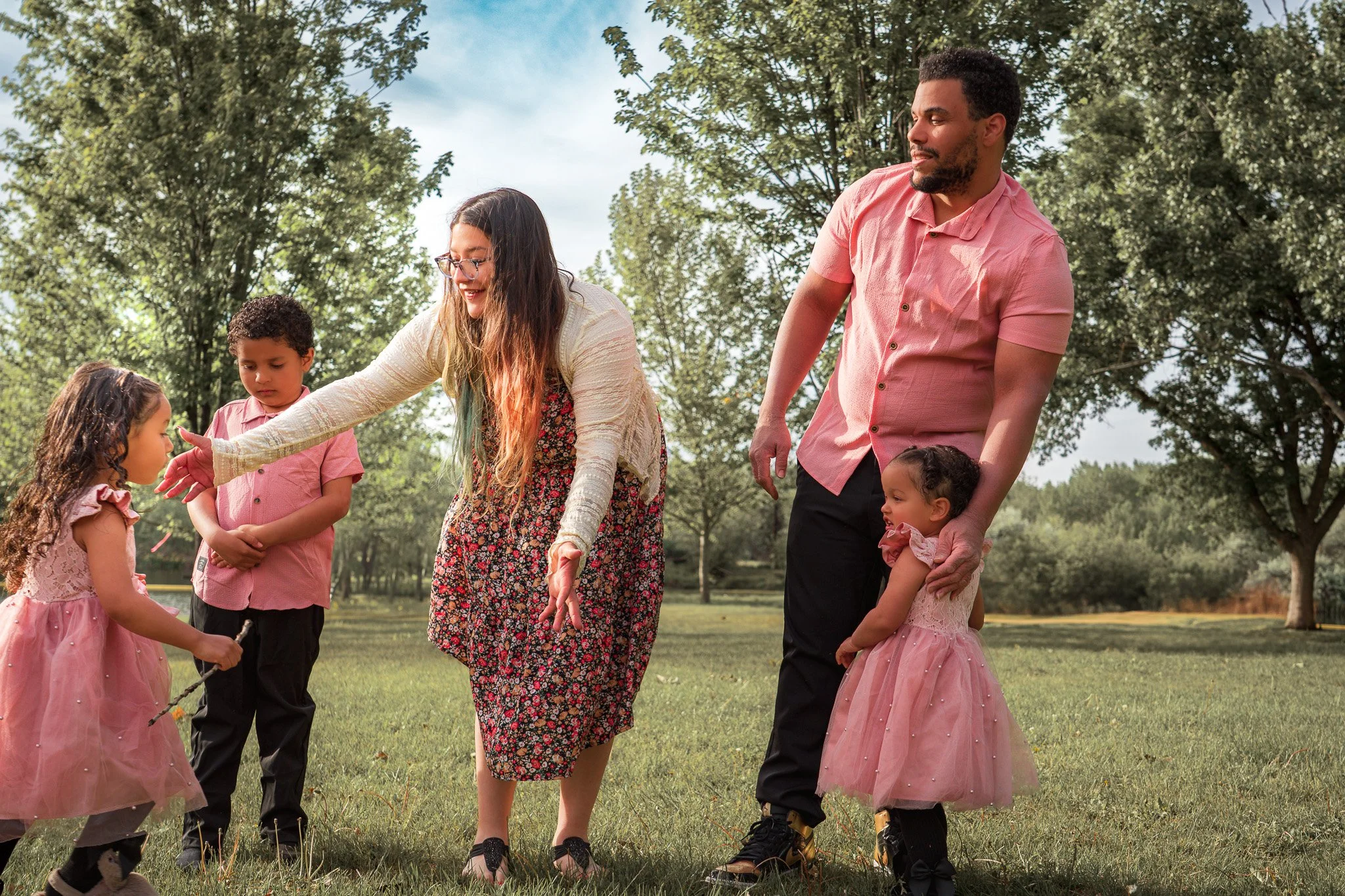 Playful family photo session in a Boise park, capturing real moments of laughter, movement, and connection. This outdoor lifestyle portrait features coordinated outfits, natural light, and heartfelt interaction—perfect for families in Boise, Meridian