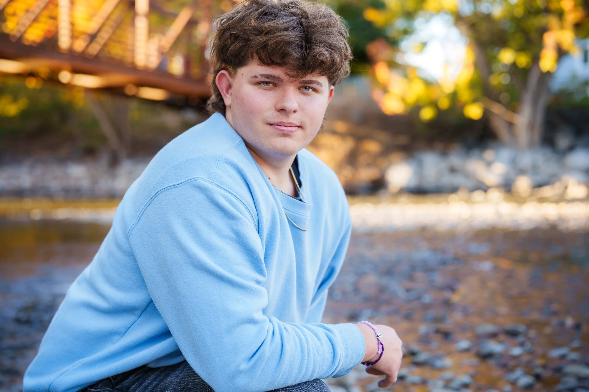 Owyhee High school senior portraits at Merrill Park in Eagle are always beautiful with the soft light reflecting off the river. This relaxed senior session captured genuine confidence and personality exactly what Forever My Media is known for across 
