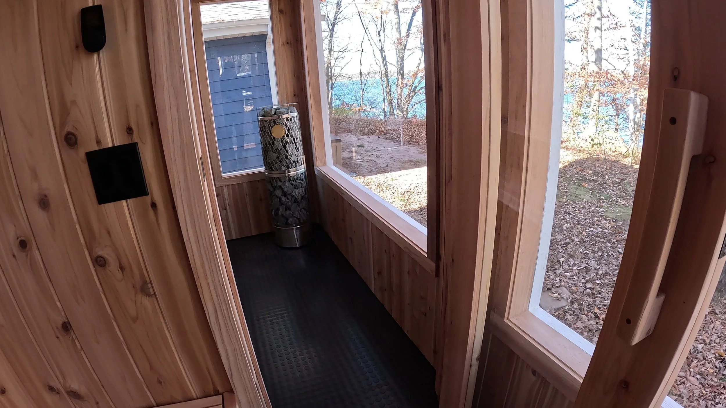 Modern custom sauna with glass door and electric sauna heater