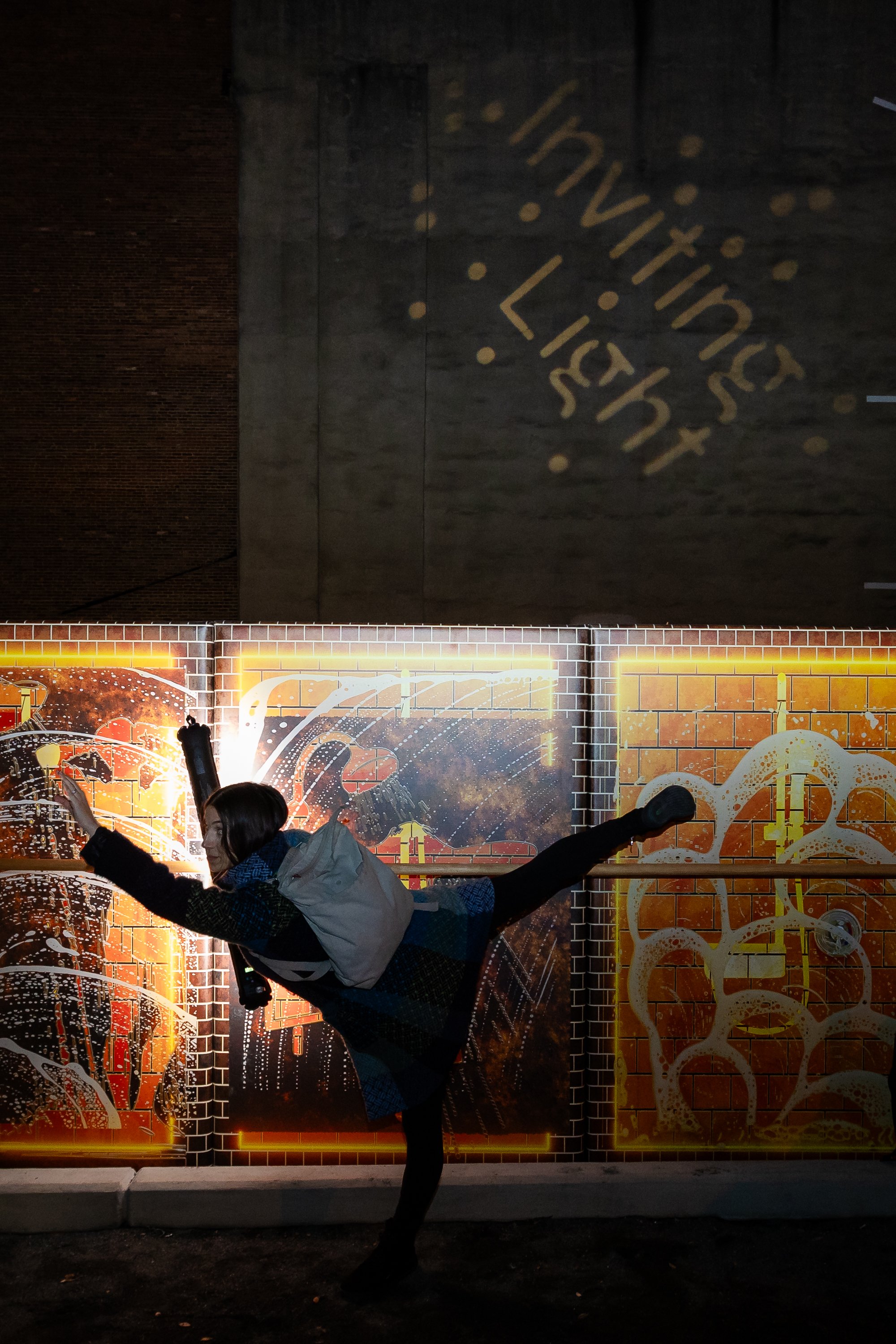 A figure poses on one leg with one arm and leg extended as part of a movement design piece responding to the elements of Soft Gym.,