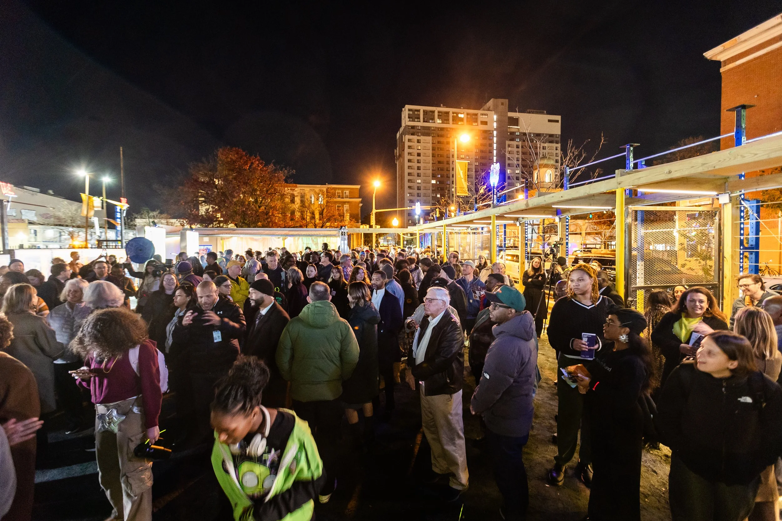 A diverse crowd at night at the Soft Gym opening.