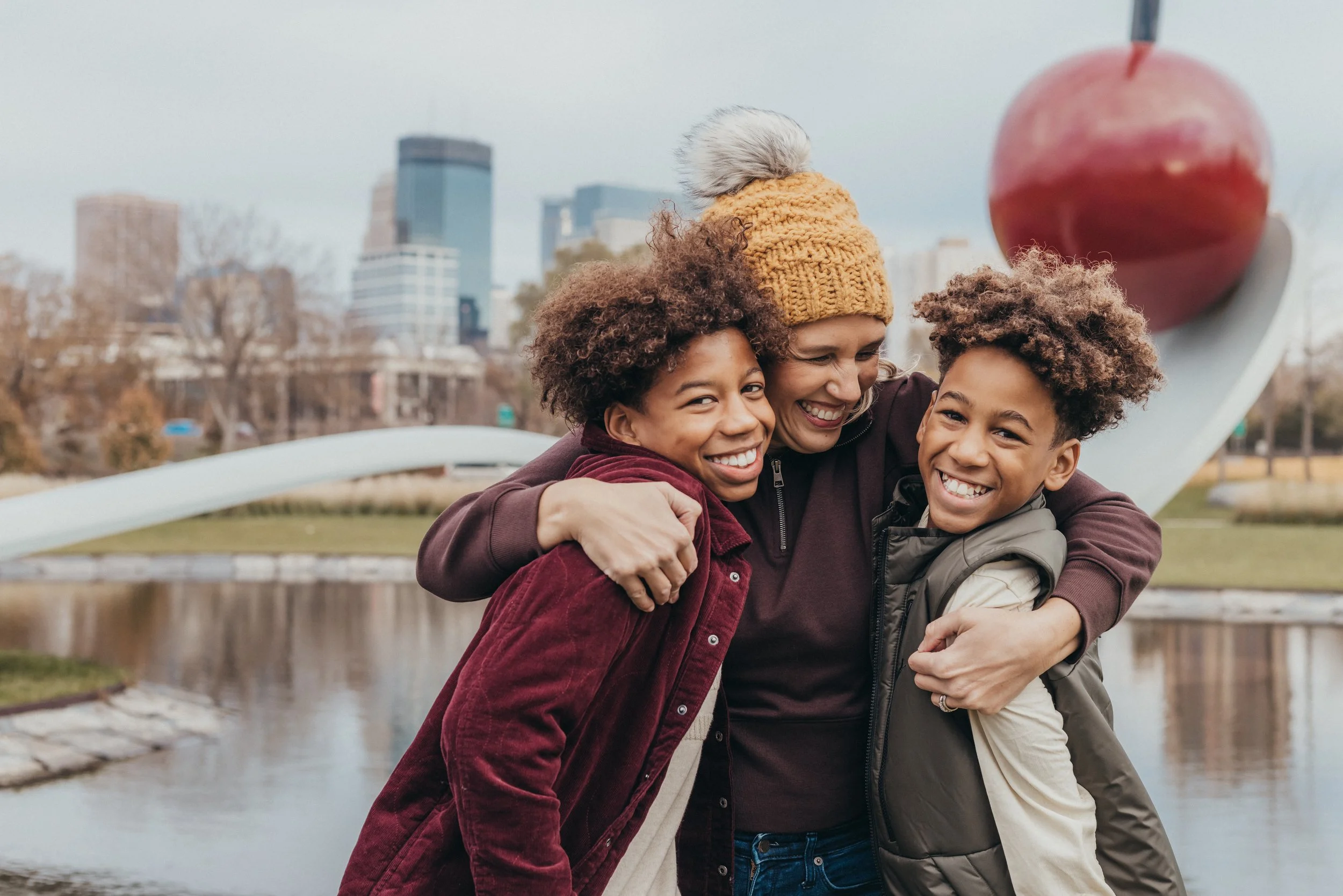 mom and sons hugging and laughing during a family photography session in Minneapolis.