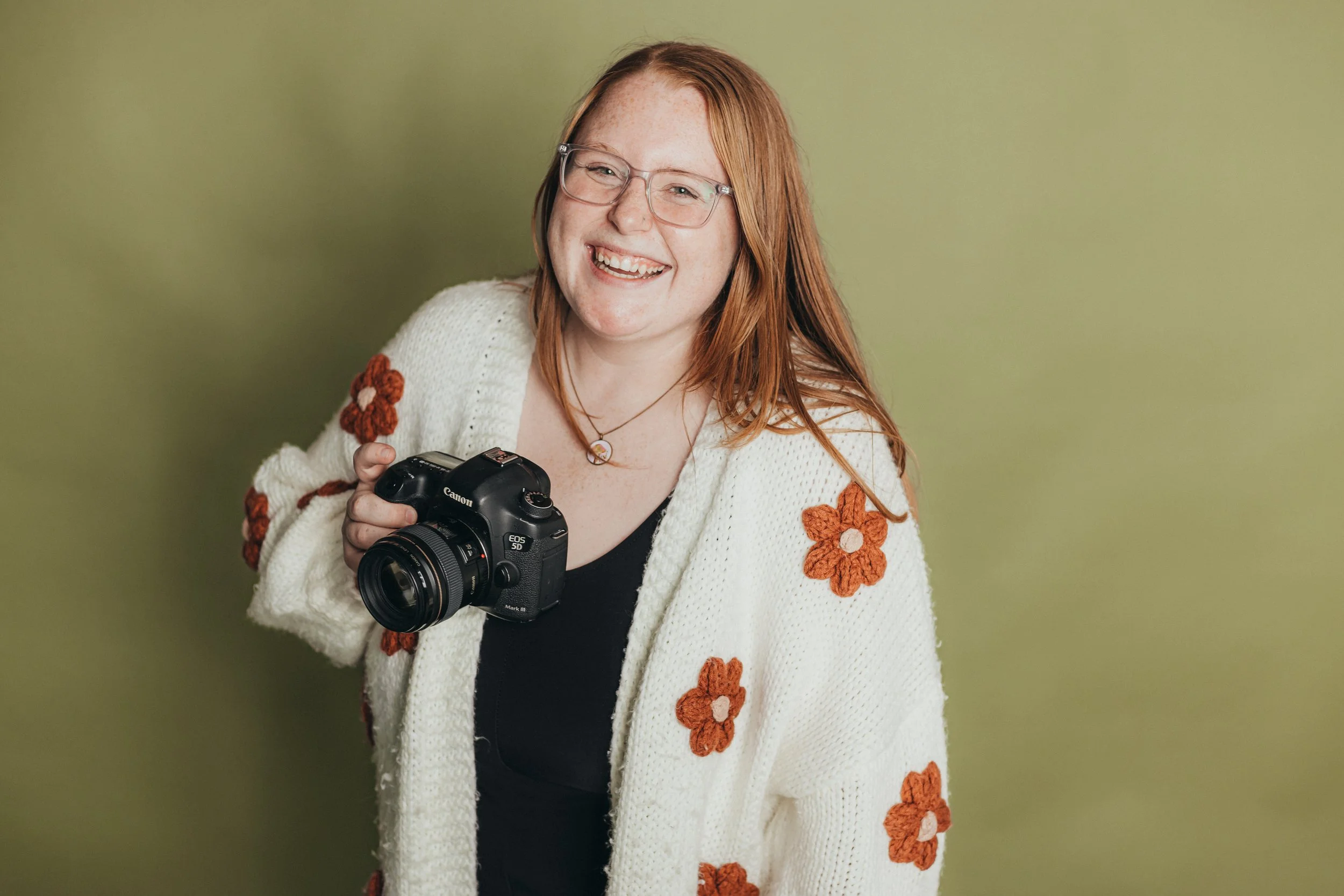 Photographer smiling while holding camera