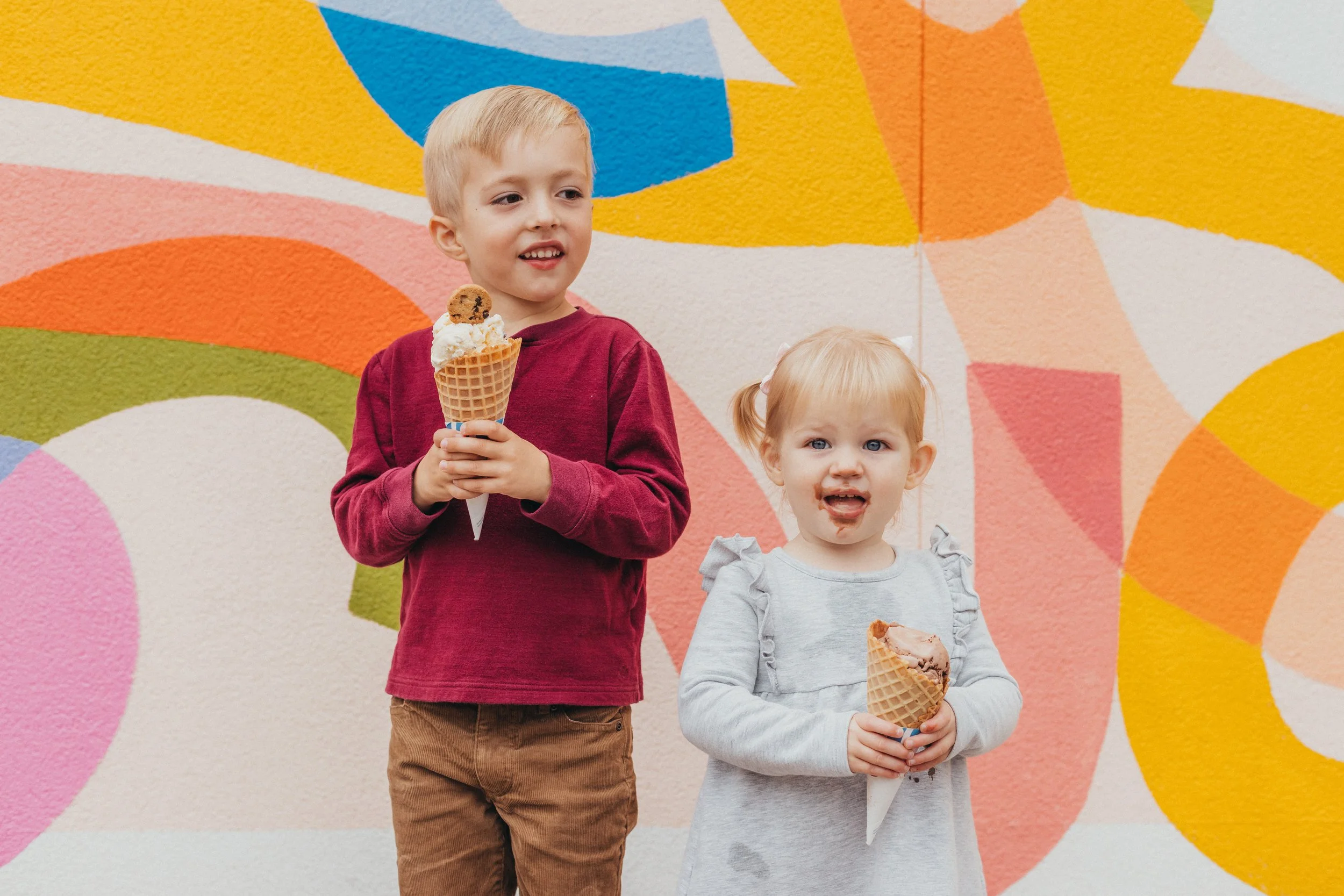 Brother and sister eating ice cream during a family photo session in minneapolis