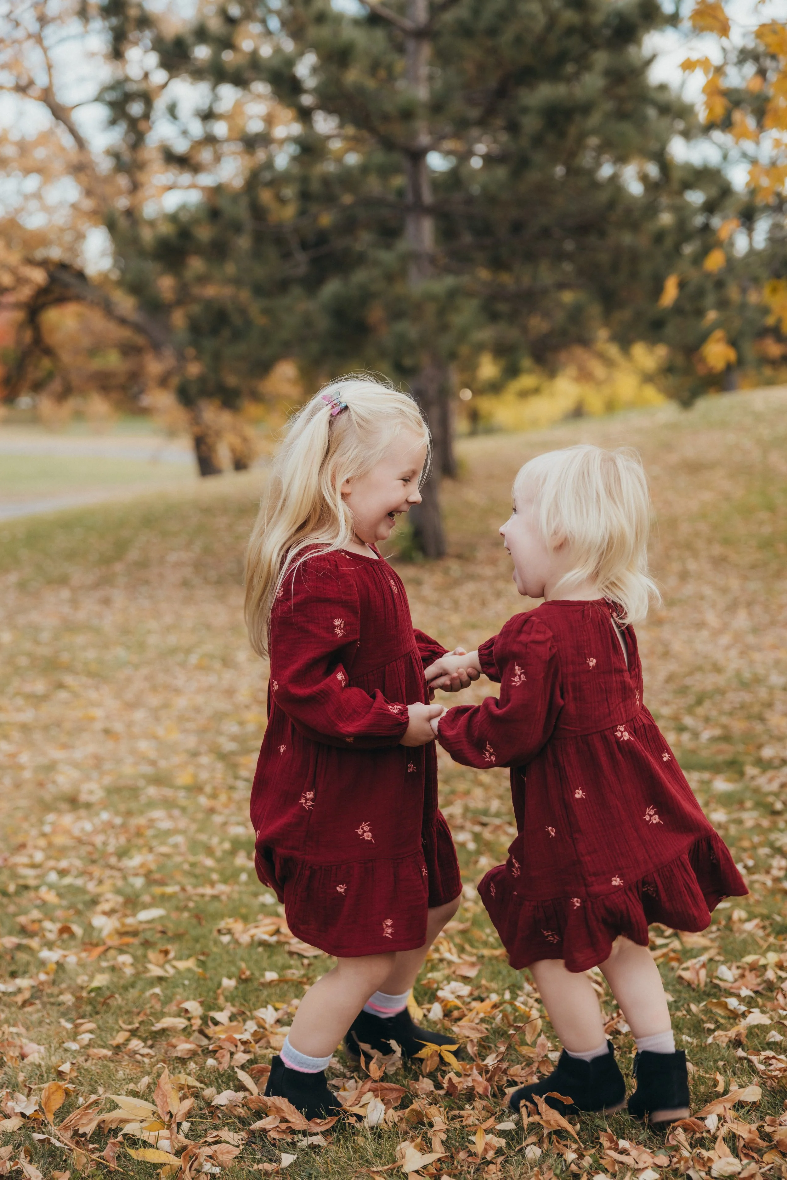 two sisters dancing during a family photo session in Minneapolis