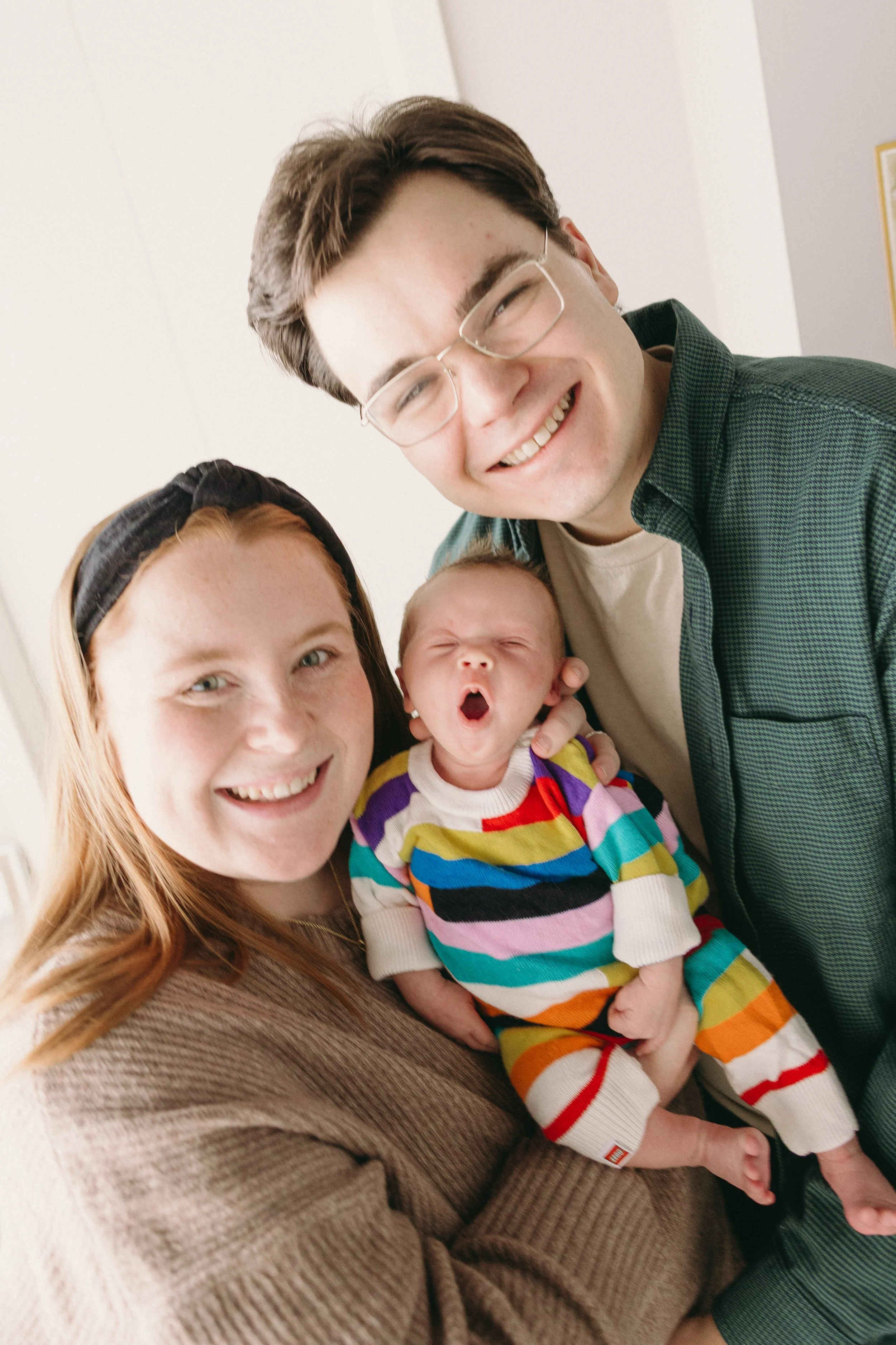 Family with new baby smiling during family photo session