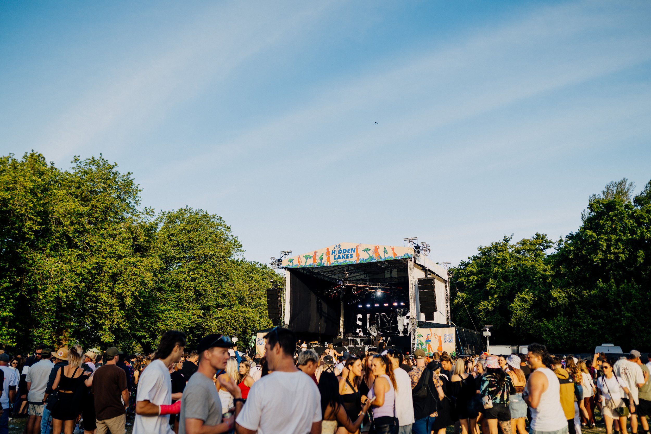 Outdoor music festival with stage and crowd, Hidden Lakes event