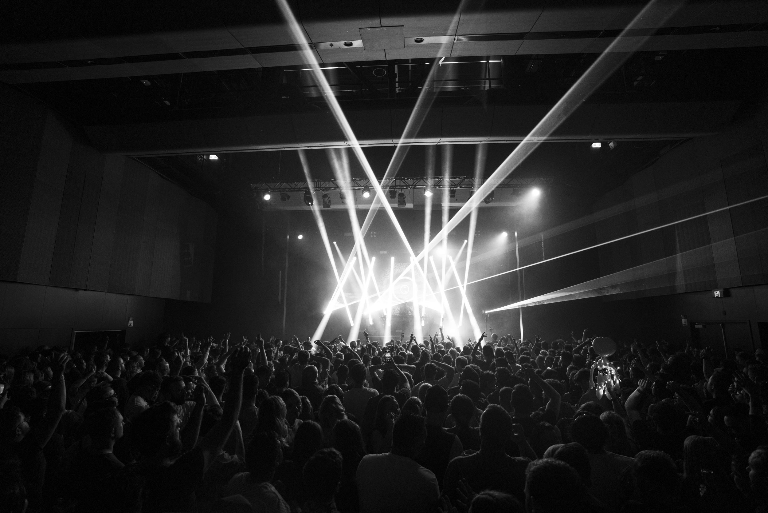 Concert crowd with stage lights and beams