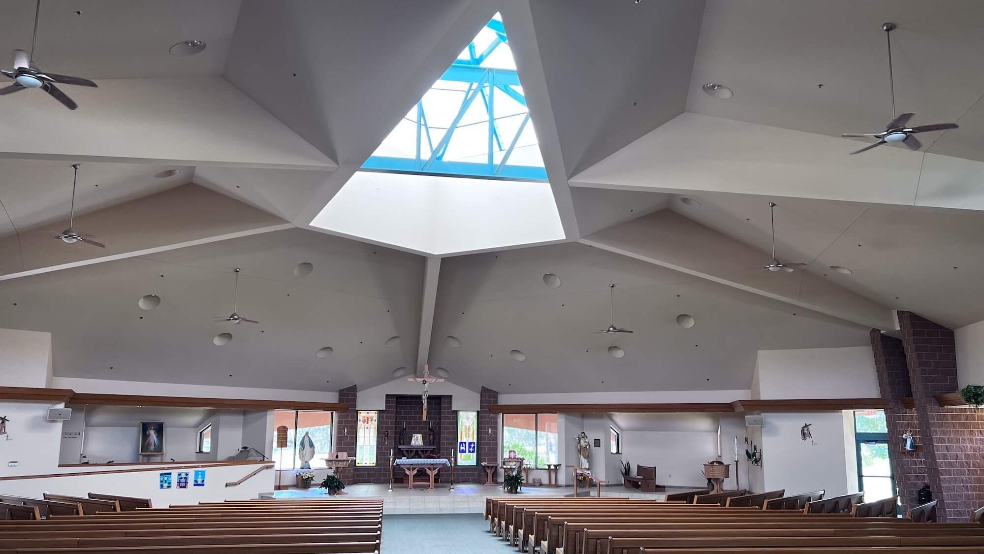 StJosephChurch+interior+main+sanctuary+with+pews+toward+alter+and+large+skylight+above.jpg