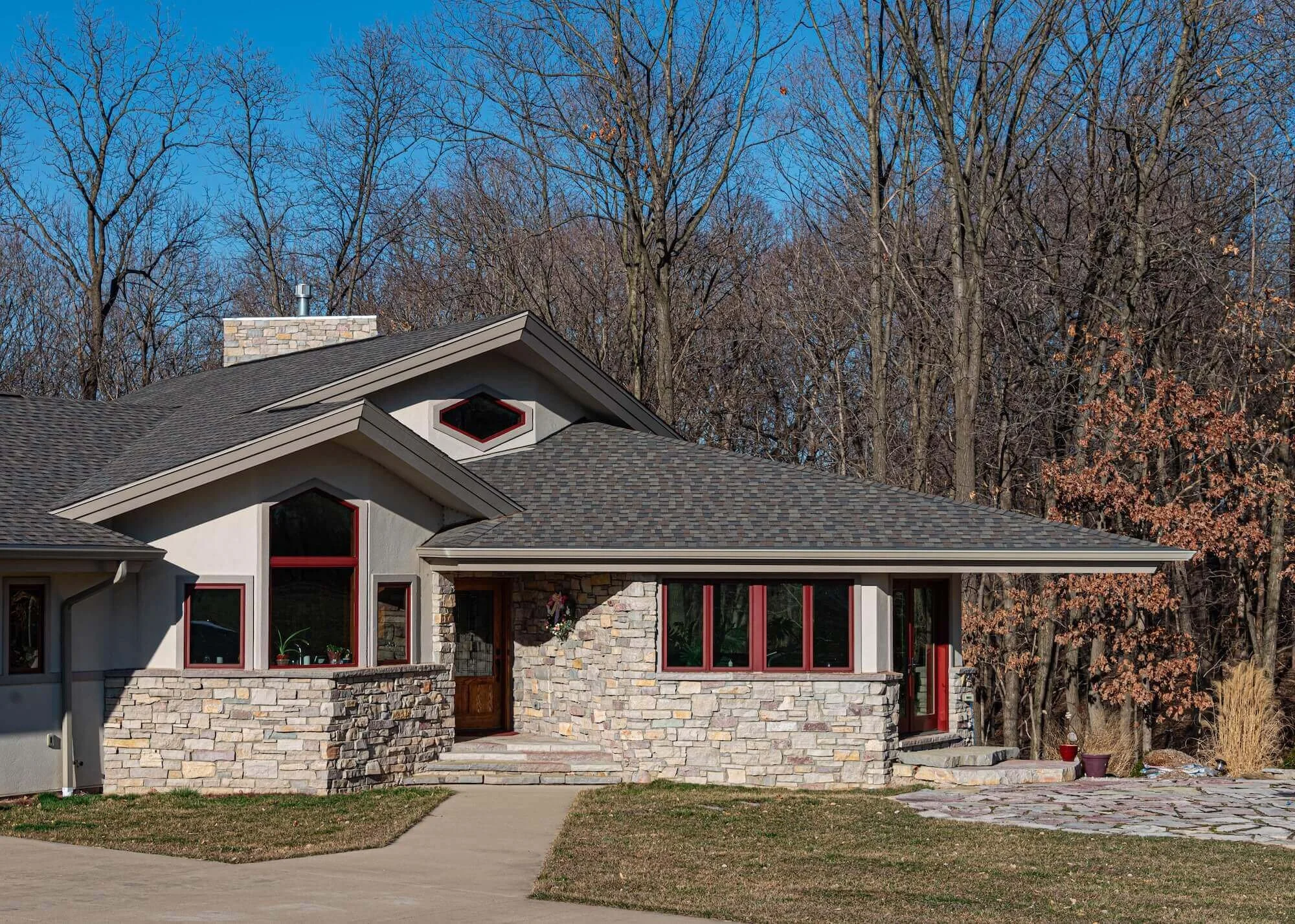 Front entry of house with grey stone dark grey roof red trim.jpg