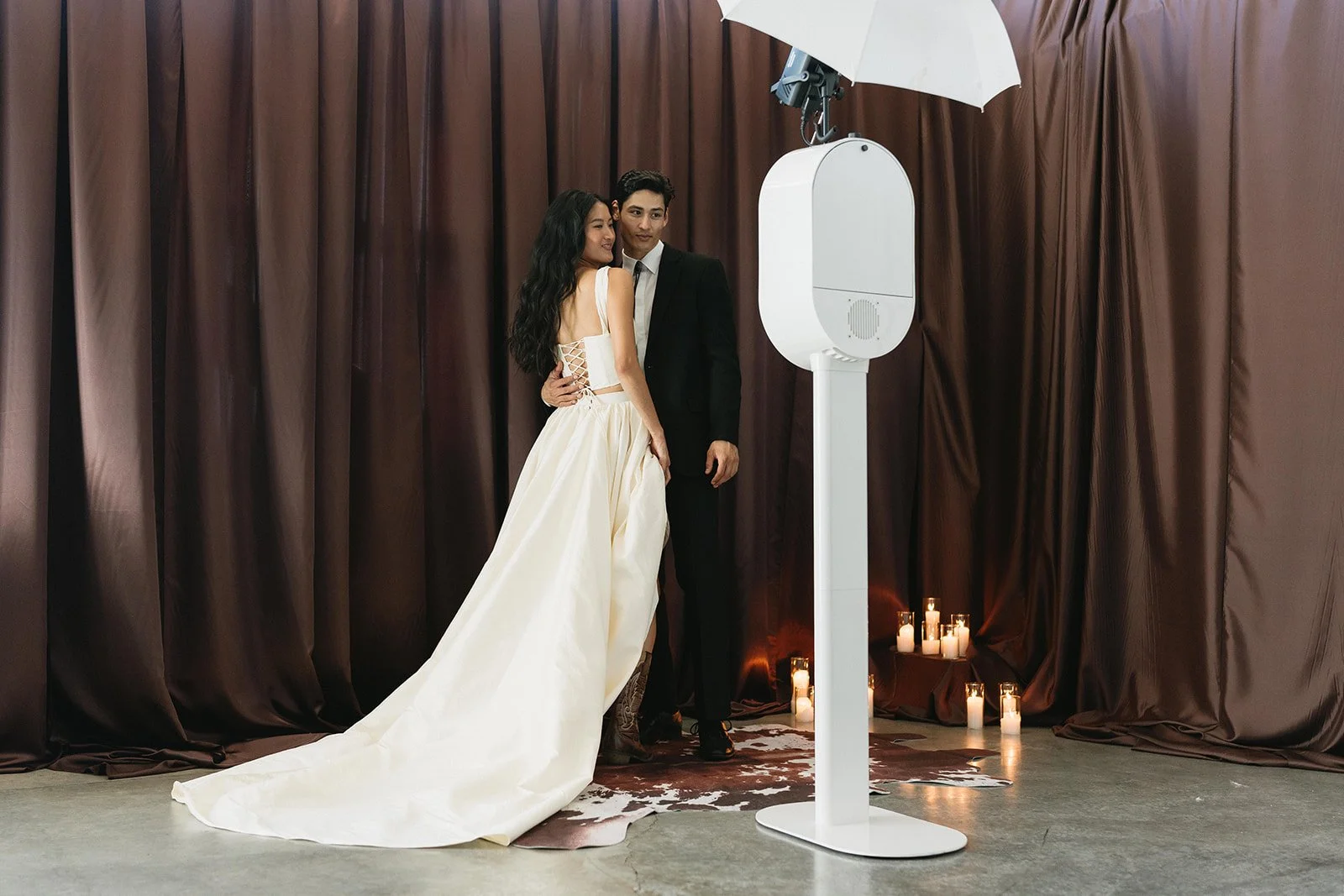 “Luxury photo booth setup with rich draping backdrop and modern styling, representing the elevated Pure Luxe backdrop collection coming in 2026.