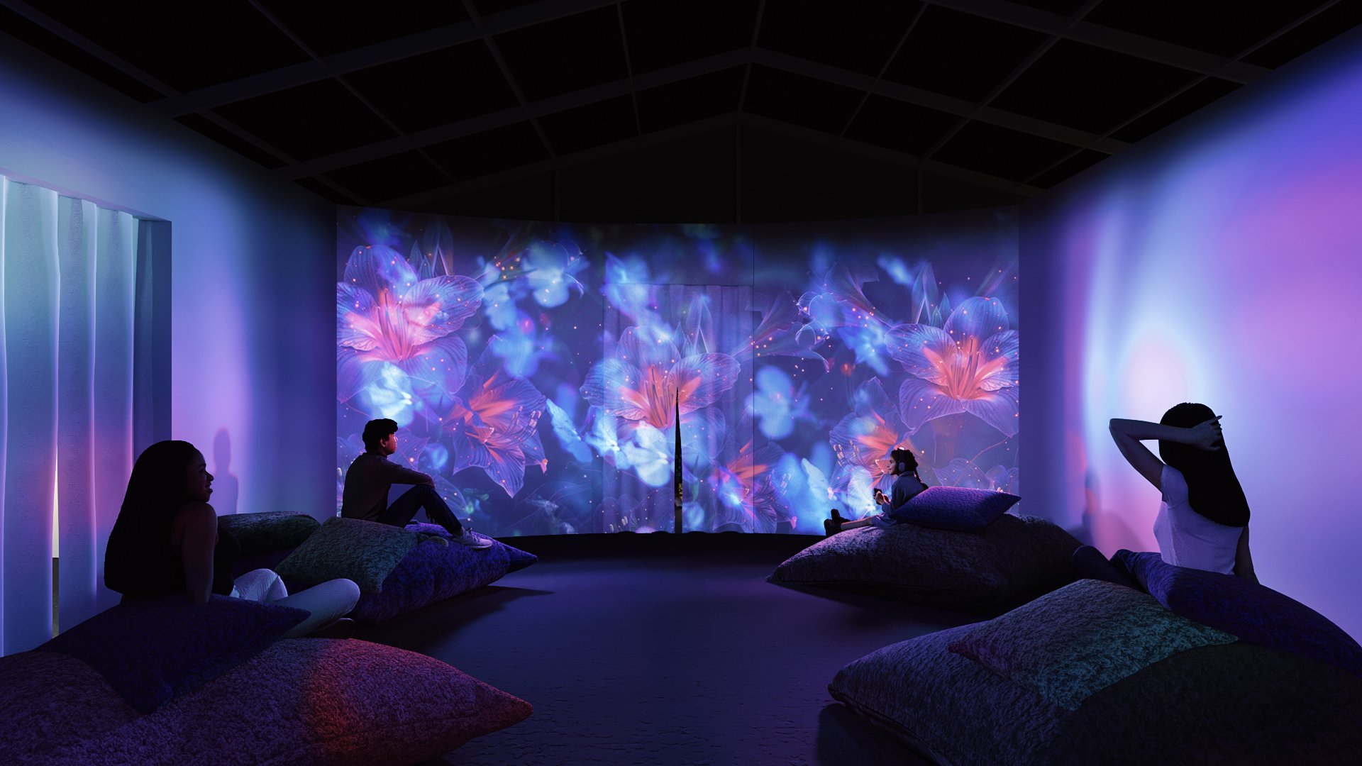 Children sitting on bean bags in a dark room with a colorful, curtain of digital flowers projected on the wall.