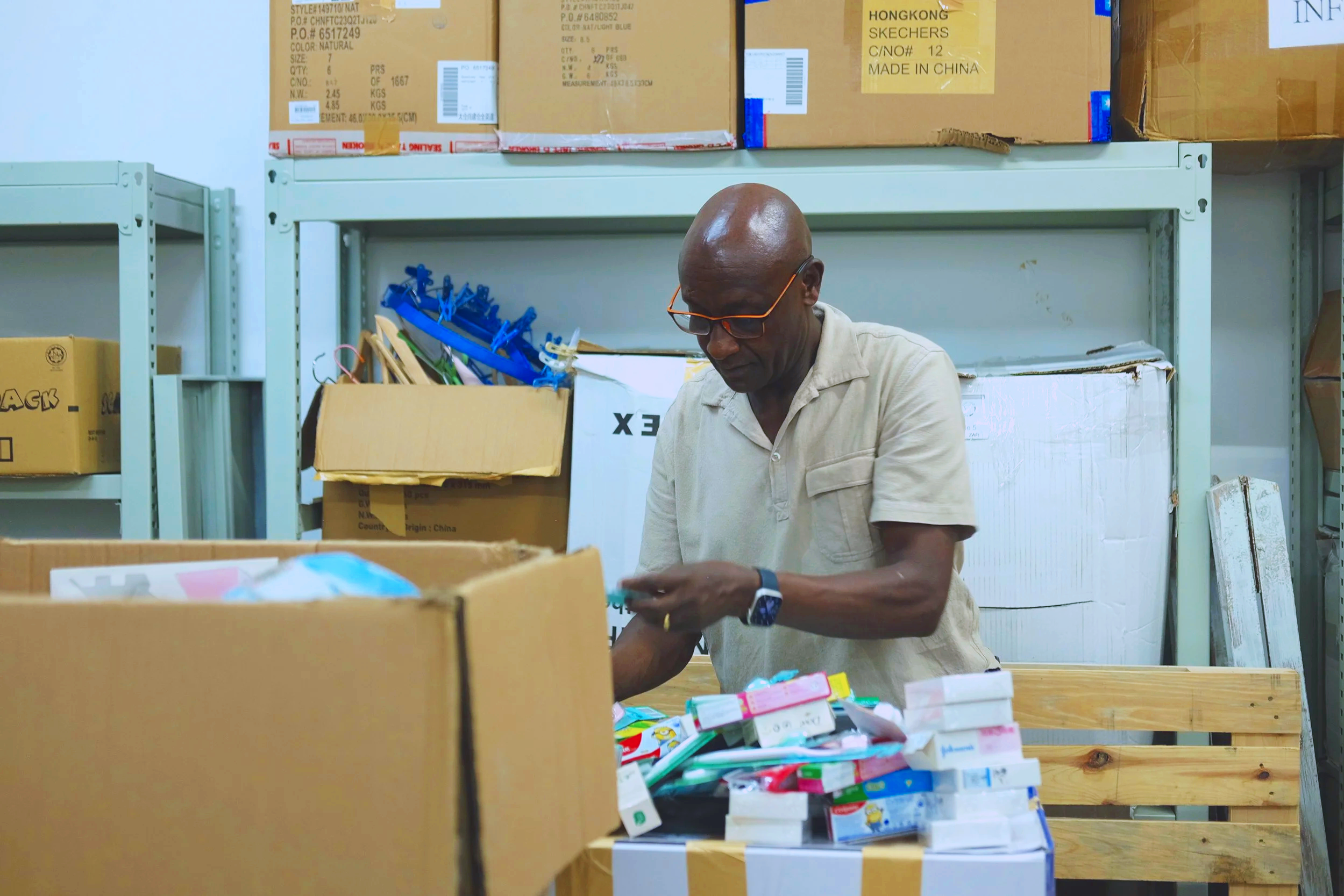 Worker organizing donated supplies in warehouse