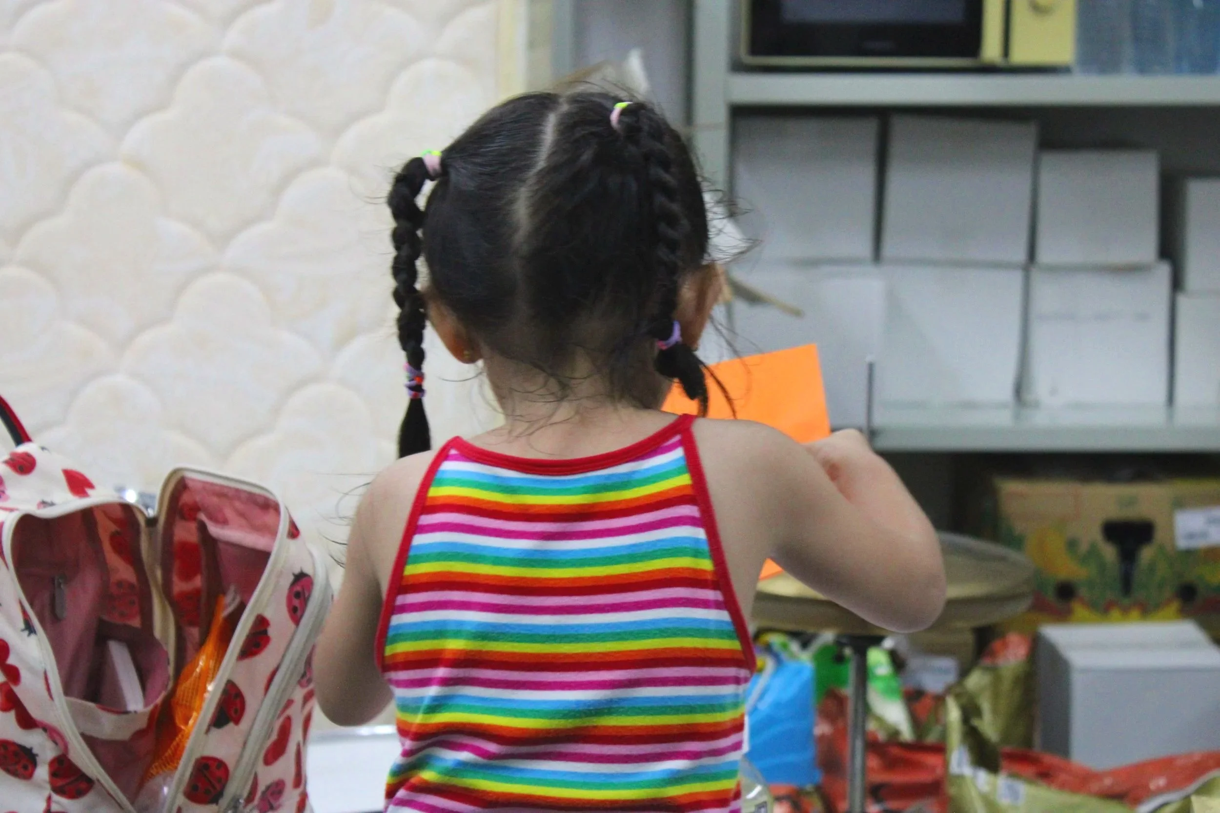 Child looking though supplies in warehouse