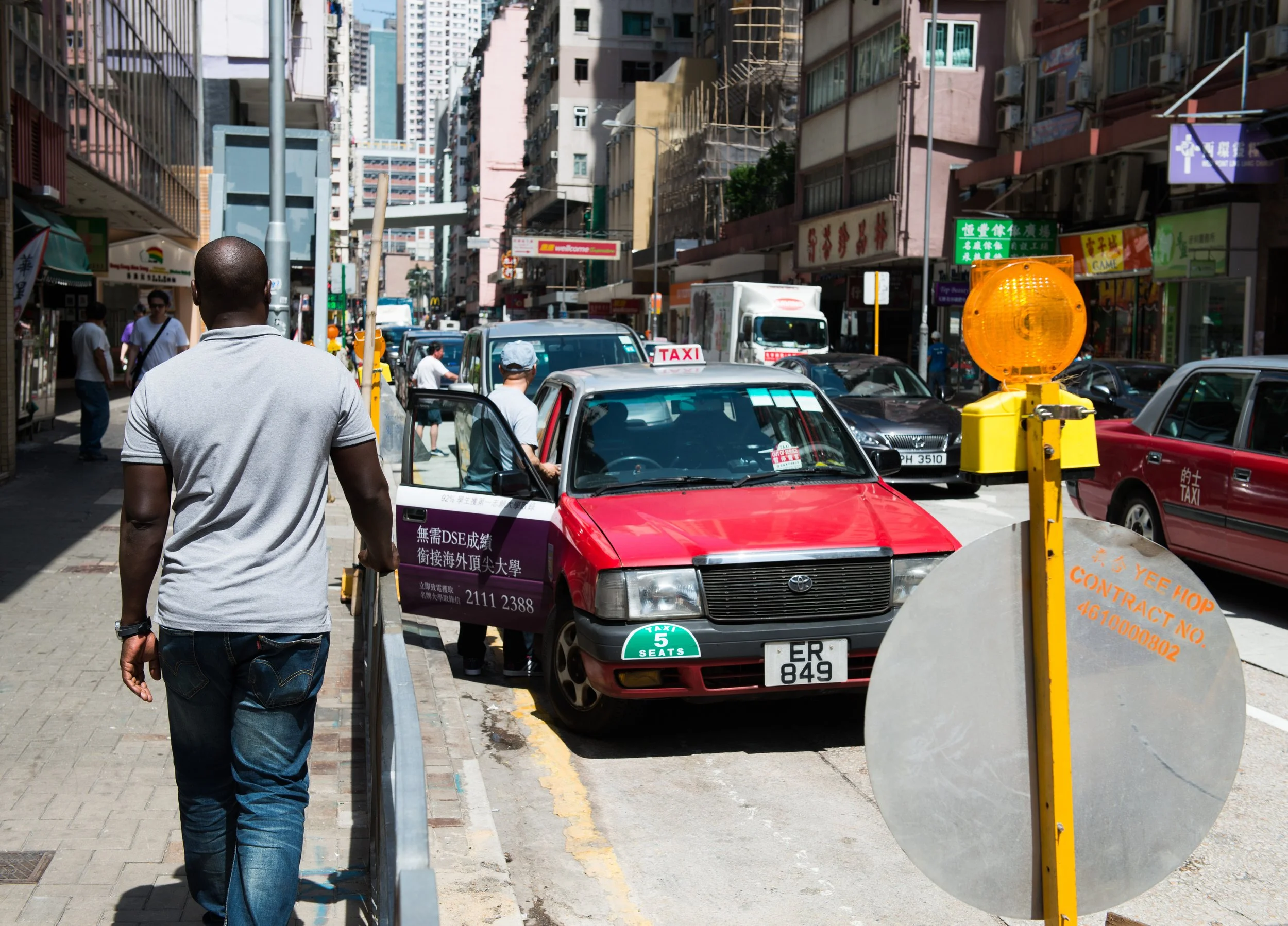An asylum seeker walking down HK street