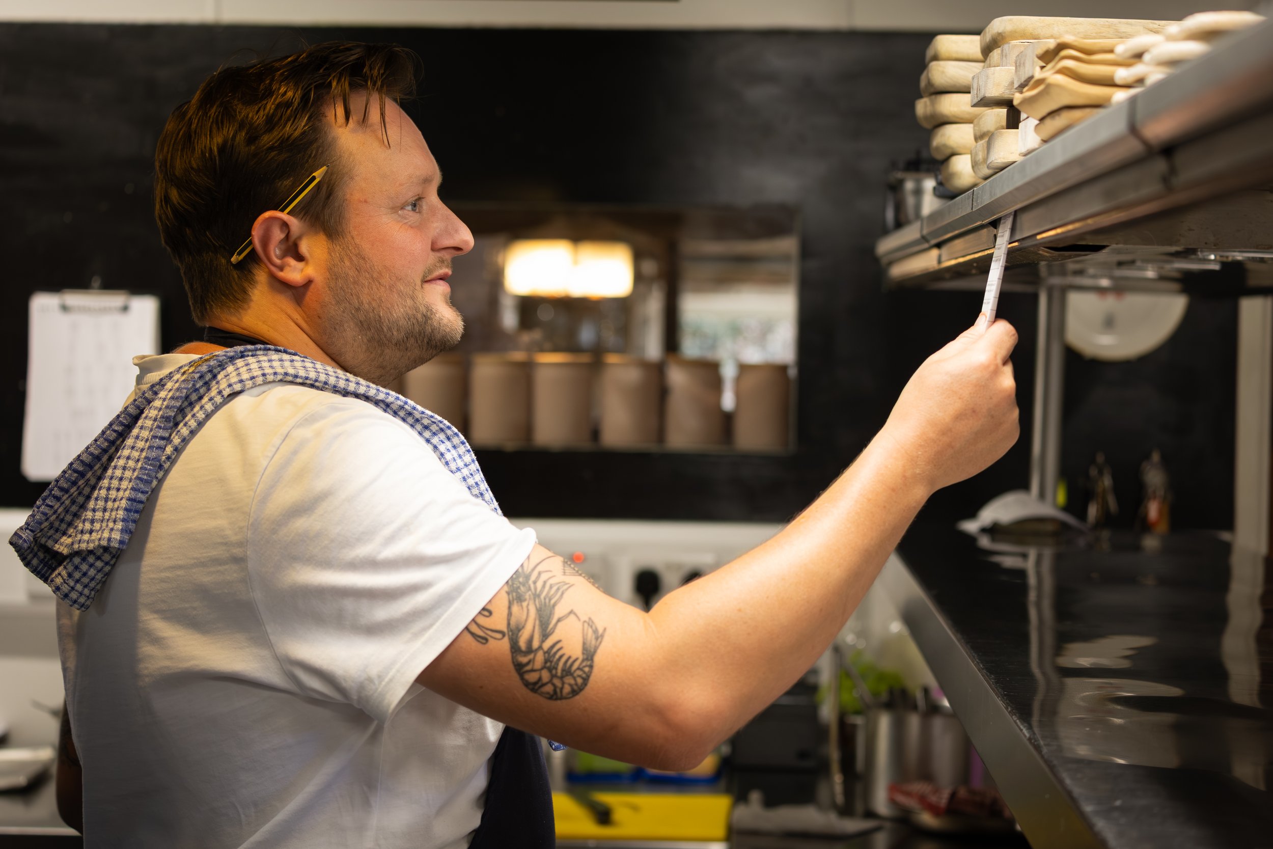 A chef checking tickets in a kitchen