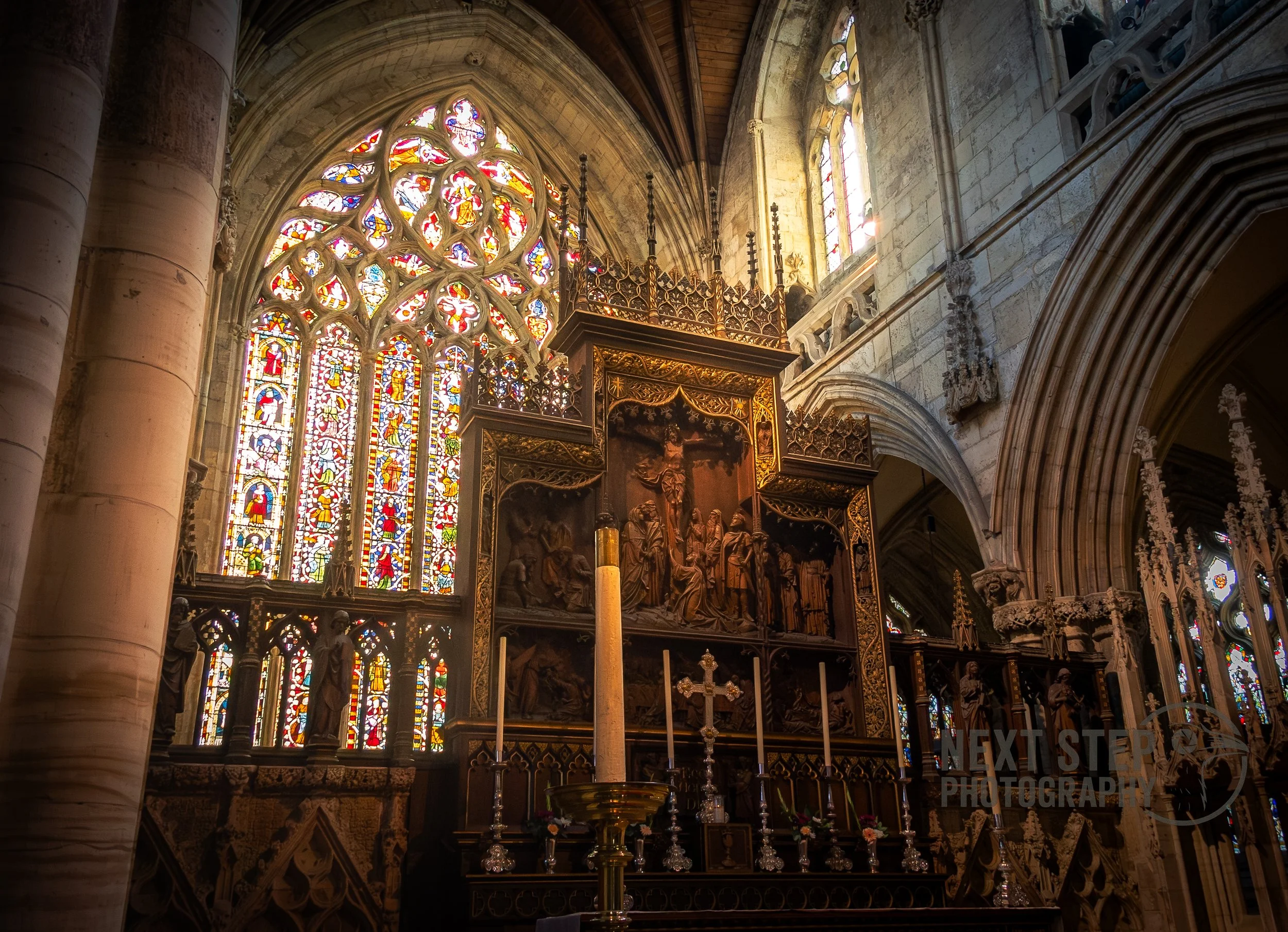 Light coming through stained glass onto an altar in a church