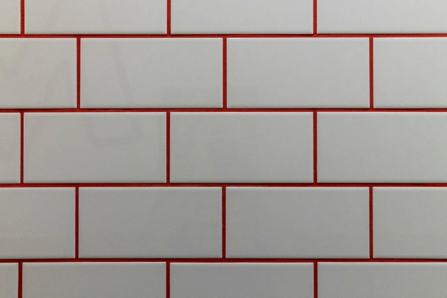 White rectangular tile with red grout lines