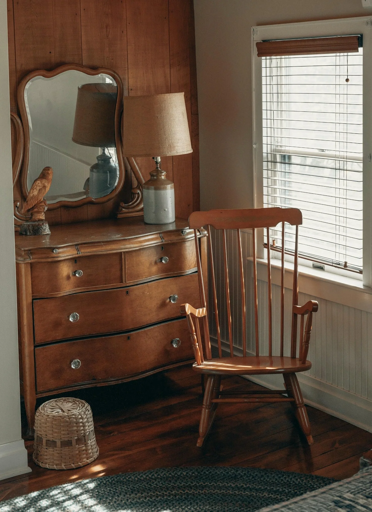 a wooden rocking chair and wooden drawers