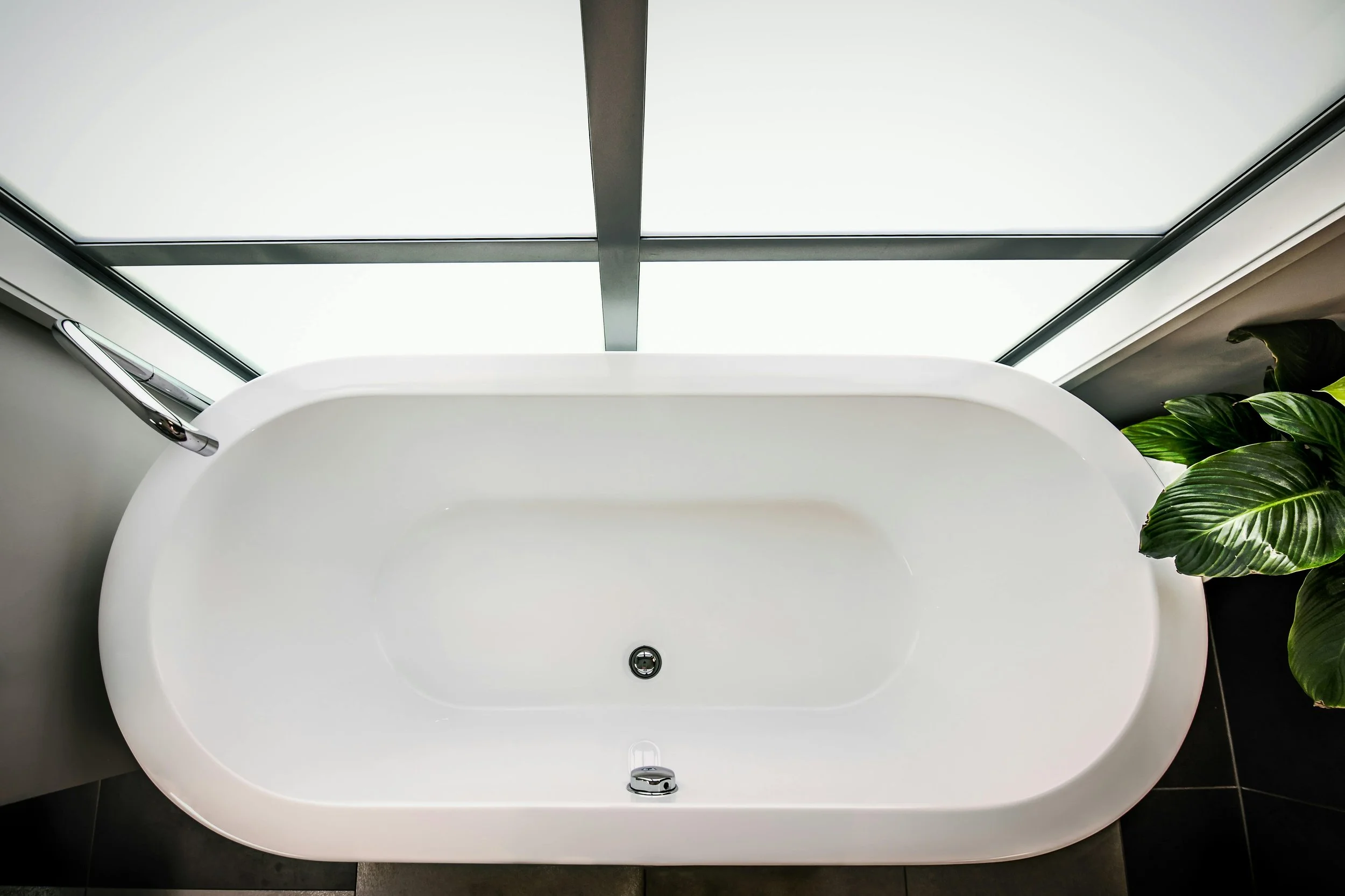 A white bathtub in front of window