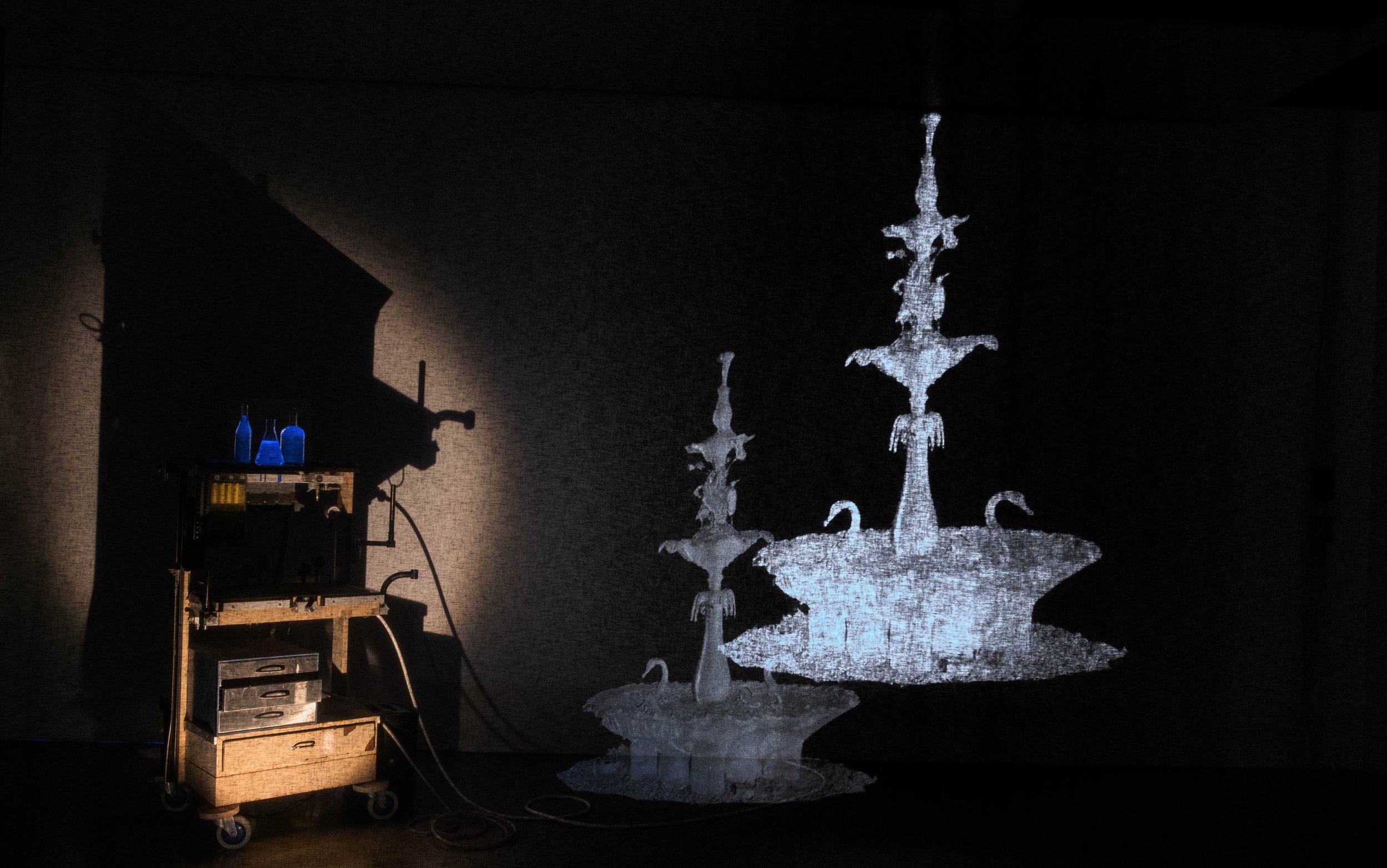 Mother's Ruin(ation), 2023. Anaesthetic gas machine, single channel projection with audio, black voile, tonic water, UV light, steel piping - Dimensions variable.
Installation view, Dunedin School of Art Gallery, New Zealand, 2023.
Photo: Justin Spi