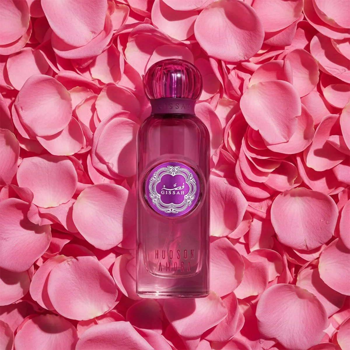 Hudson Amora EDP bottle atop flower arrangement, showcasing unisex luxury fragrance by Gissah