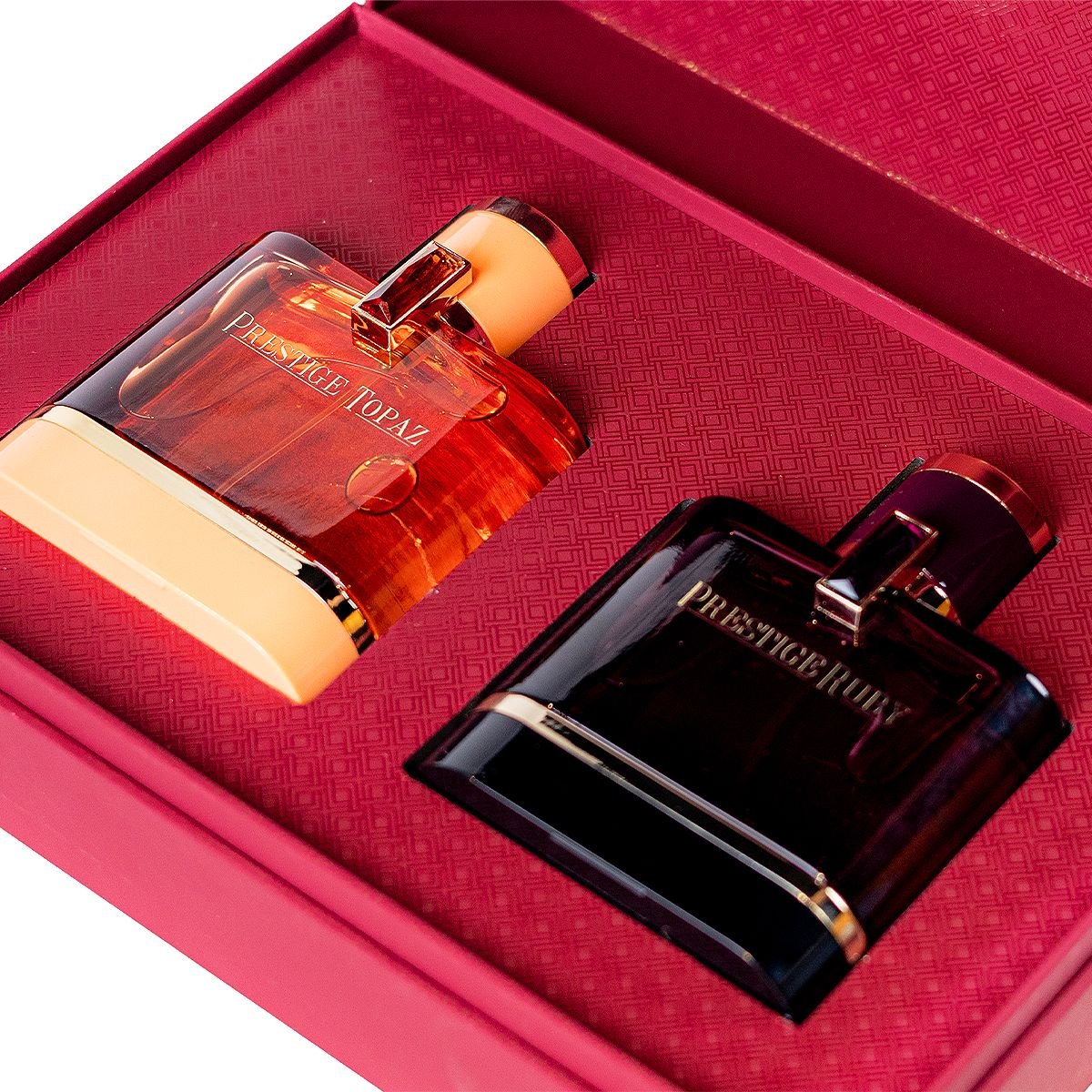 Close up of Al Majed Oud Prestige Topaz and Prestige Ruby perfumes inside box, premium gift set UK
