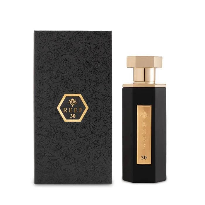 Reef 30 fragrance bottle beside its branded box on white background