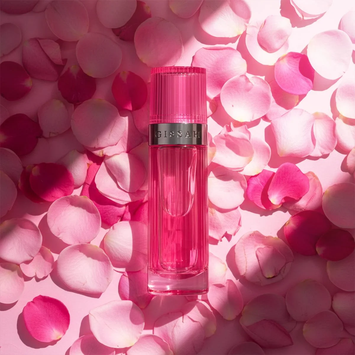 Gissah Neo Bloom body oil roll-on surrounded by pink rose petals