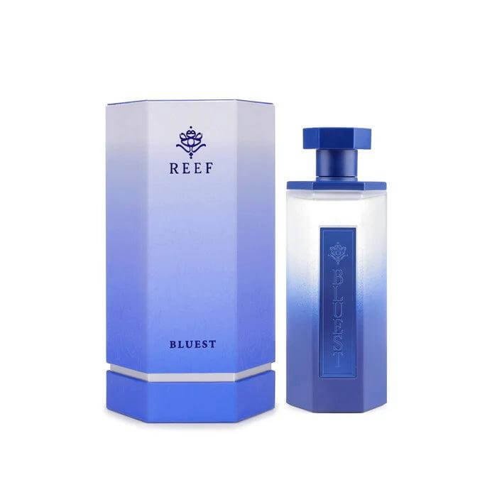 Bluest perfume bottle placed beside its luxury packaging on white background