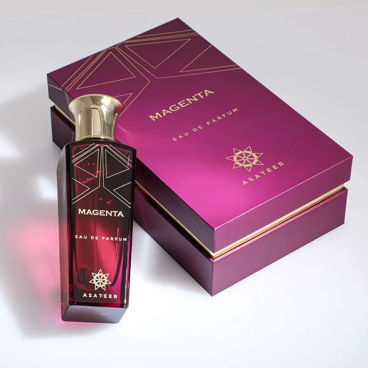 Asateer Magenta Eau De Parfum 80ml laid beside luxury branded box UK