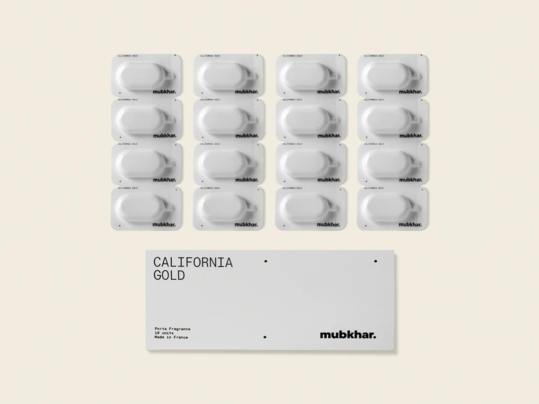 Mubkhar Porta Fragrance California Gold capsules next to box, luxury portable fragrance UK