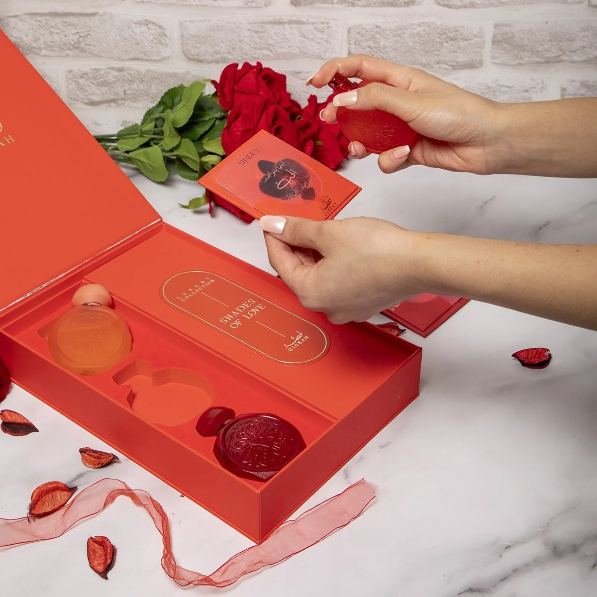 Gissah Shades Of Love perfume in use with luxury gift box in background