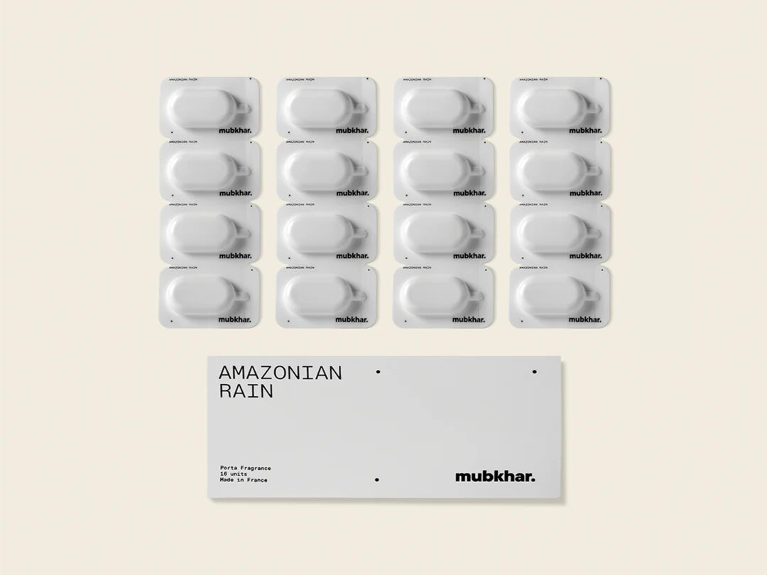 Mubkhar Porta Fragrance Amazonian Rain capsules next to box, luxury portable fragrance UK