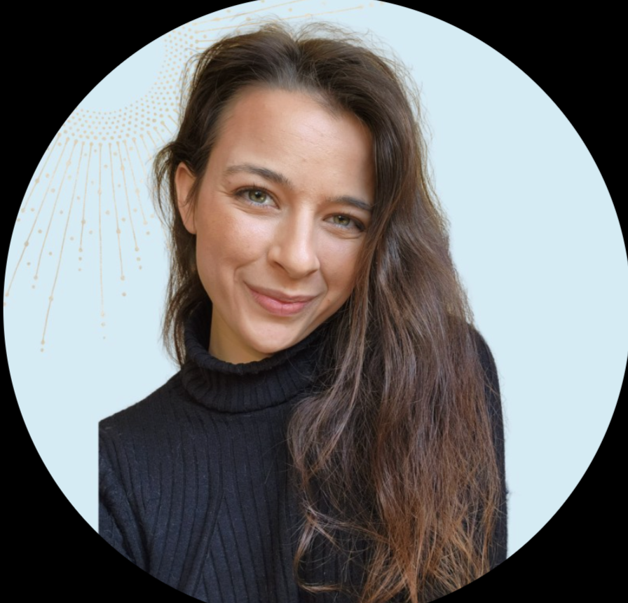 Portrait of a woman with long brown hair, wearing a black turtleneck, smiling, against a light blue background with a decorative gold pattern.