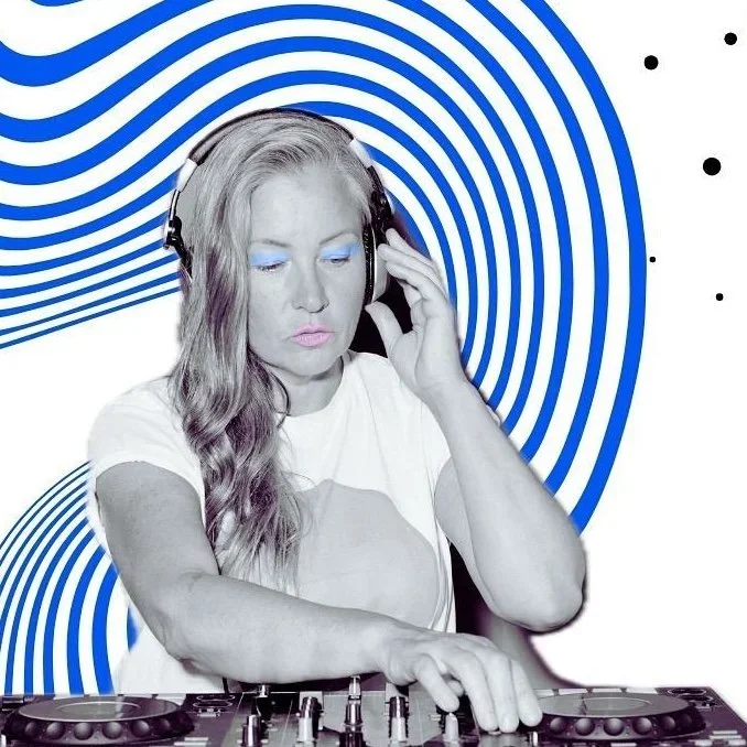 A woman with long wavy hair wearing a white T-shirt and headphones, DJing with a colorful, abstract blue and white background.